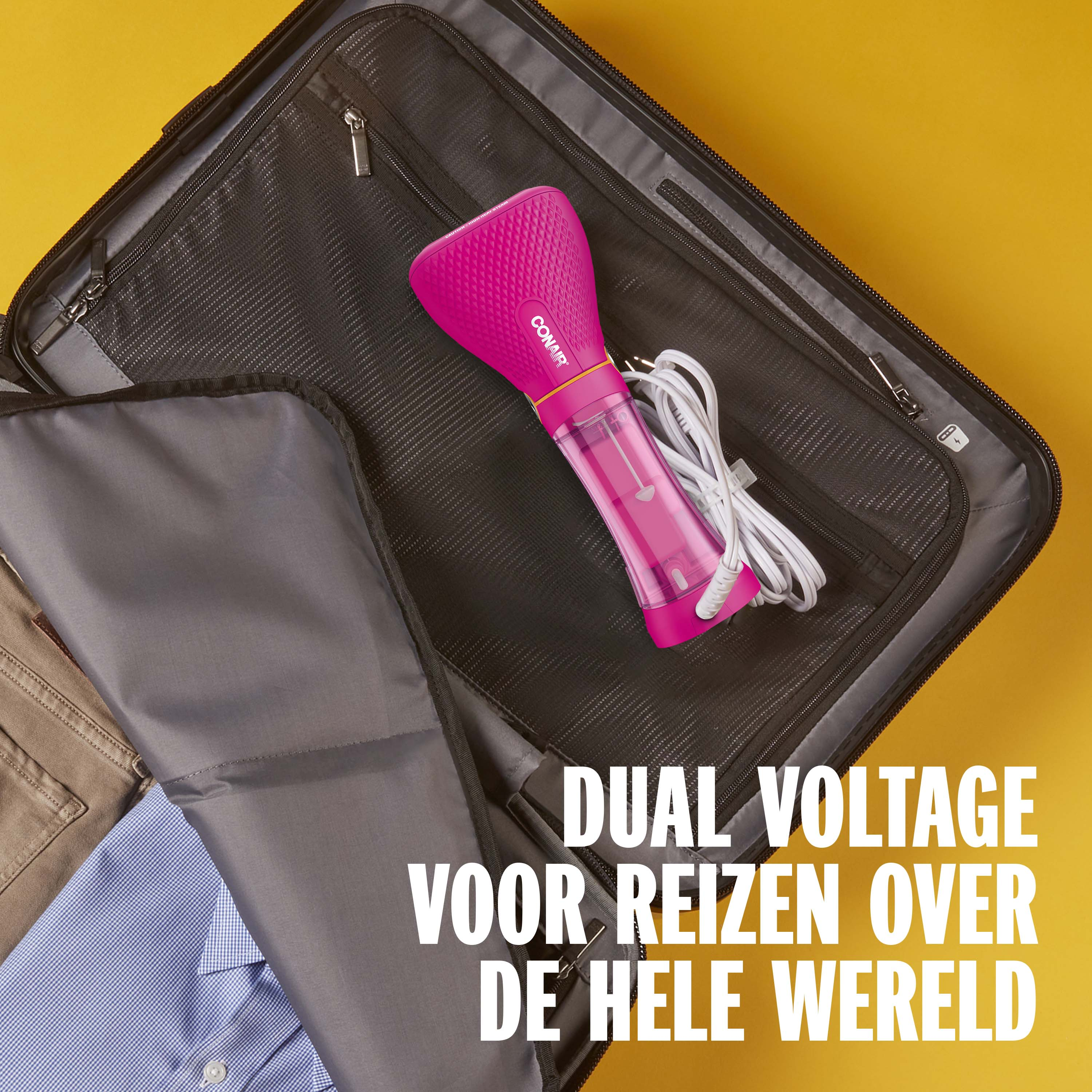 Pink hand steamer lies in a suitcase next to clothes.