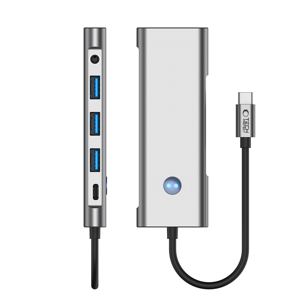 Un hub USB-C argento con porte e cavo di ricarica.