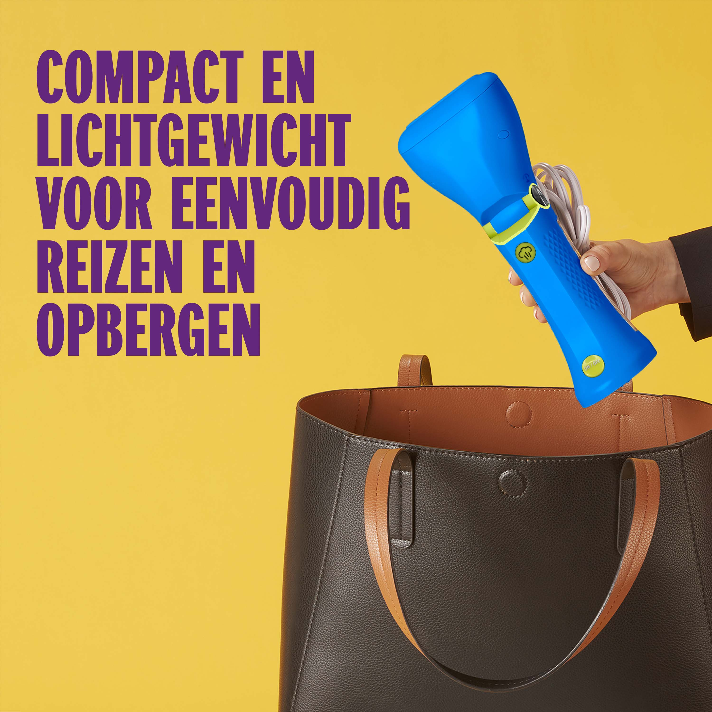 A hand holds a blue steam iron over a brown bag.