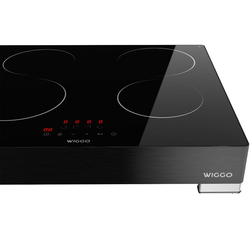 Black induction hob with four cooking zones and digital display.