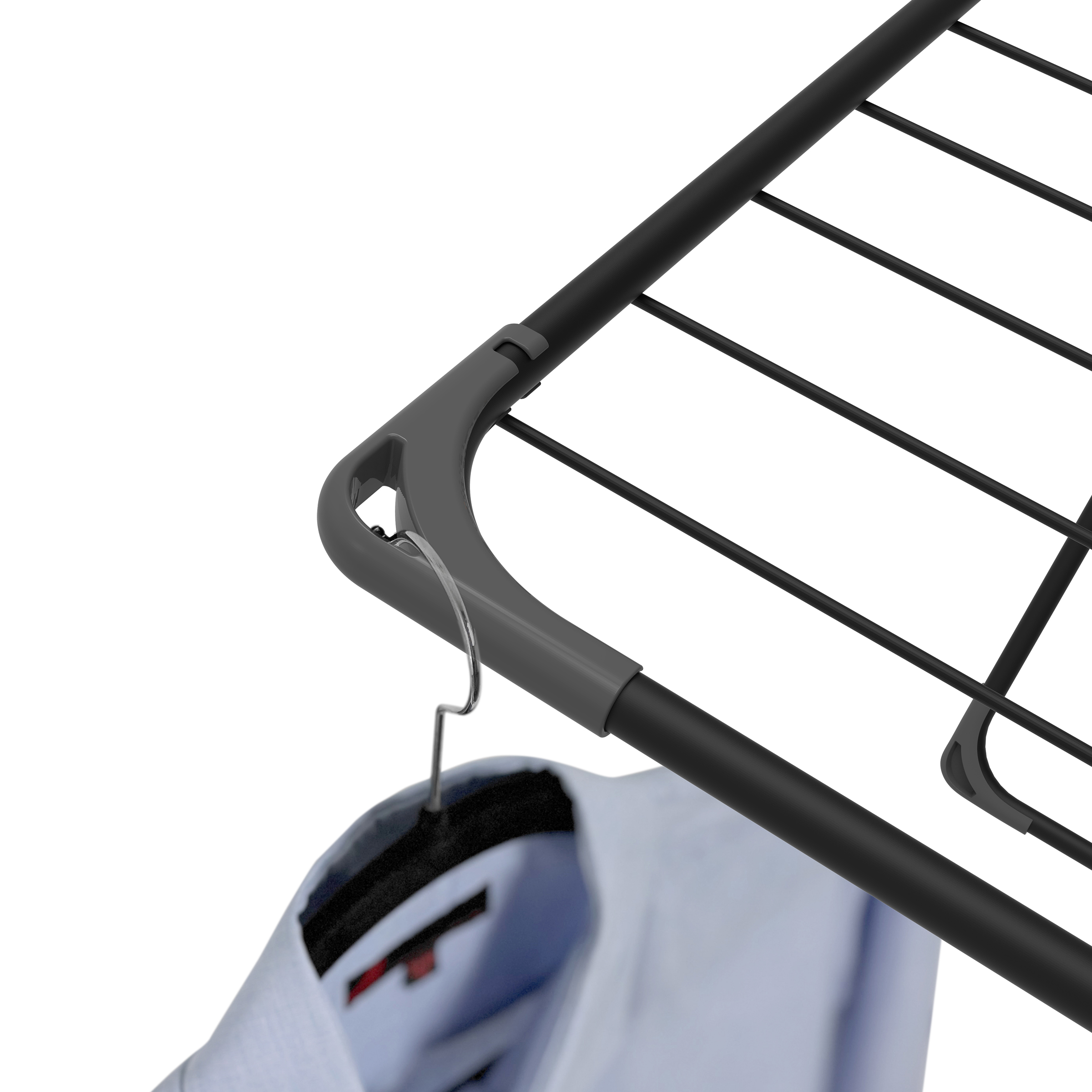 A light blue shirt hangs on a hanger from a black drying rack.