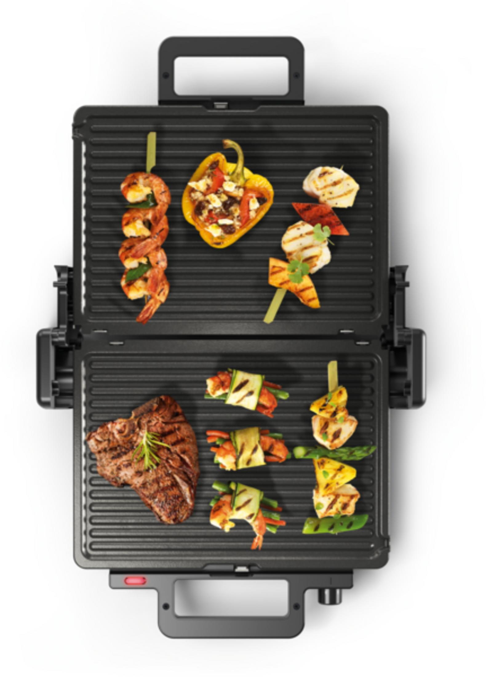 Grilled shrimp skewers, stuffed pepper, chicken & vegetables on a grill.