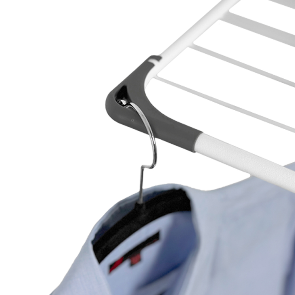 A shirt hangs on a hanger on a drying rack.