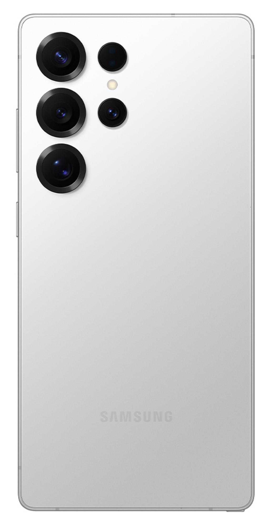 Tył białego smartfona Samsung z czterema obiektywami aparatu i lampą błyskową.