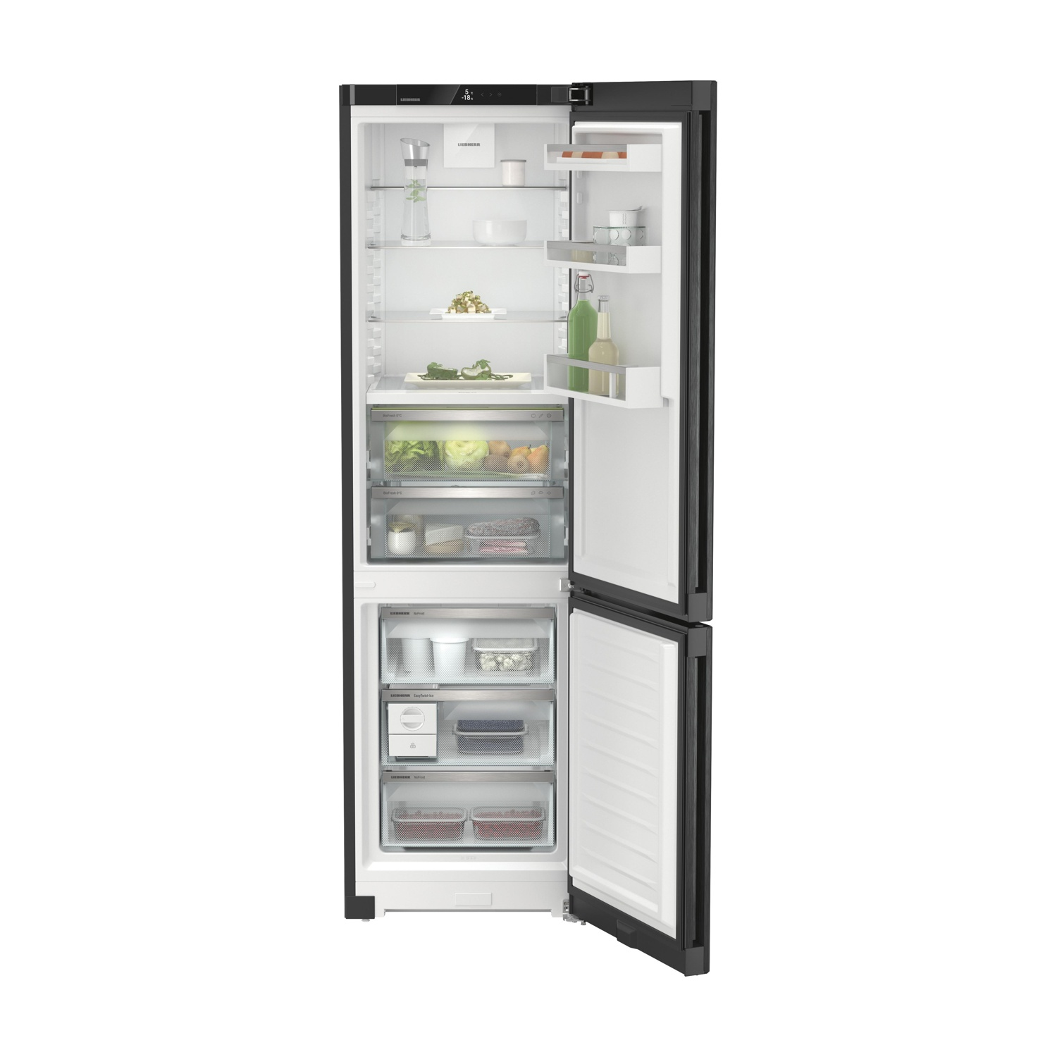 Un refrigerador negro abierto lleno de alimentos frescos.