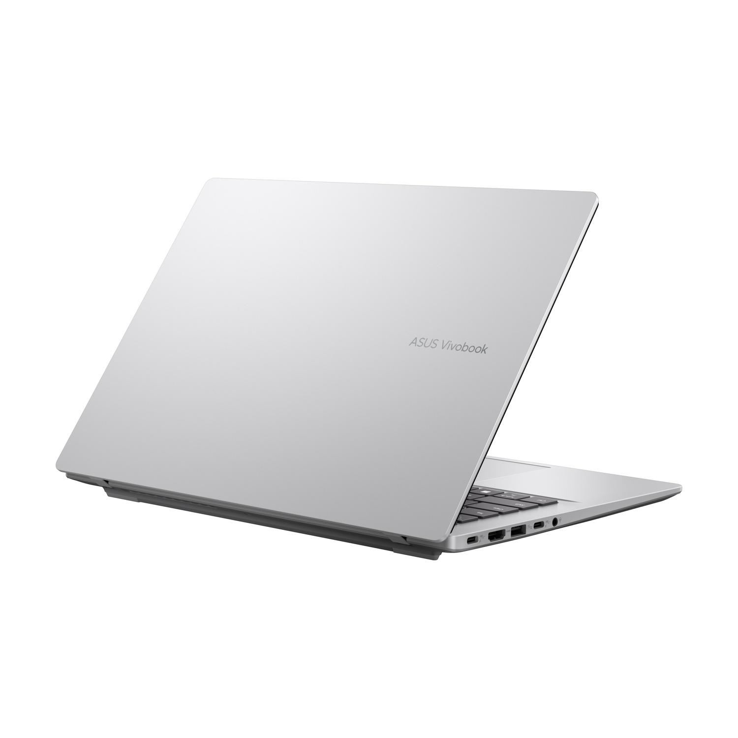 Un laptop ASUS Vivobook argentato è aperto, mostrando tastiera e porte.