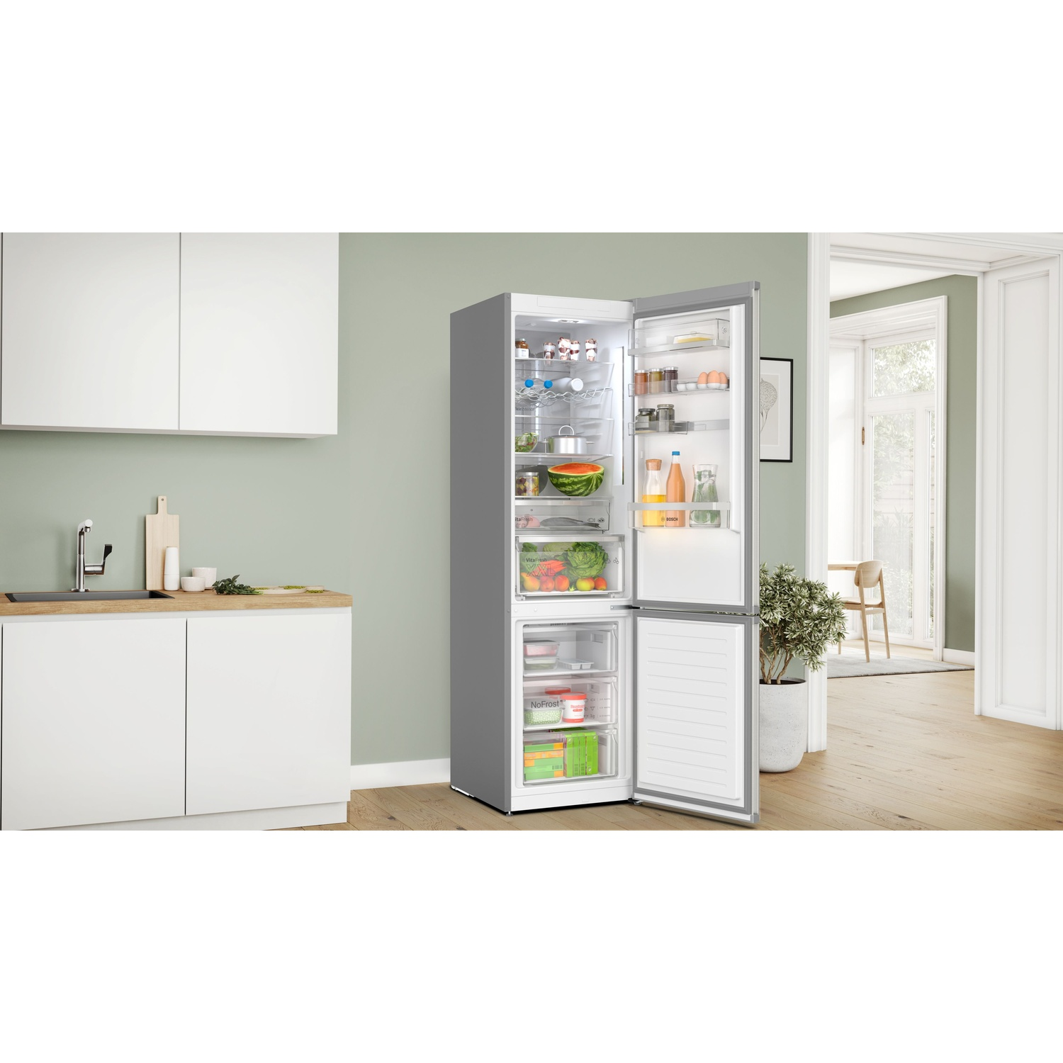 Un refrigerador abierto en una cocina, lleno de alimentos.