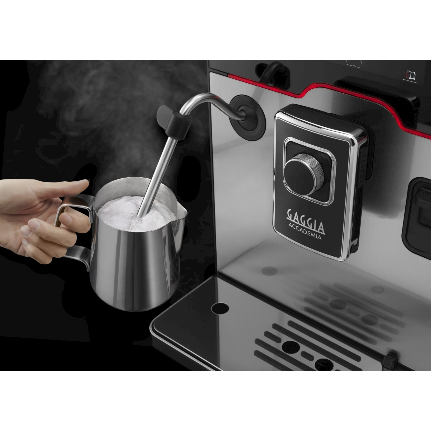 A hand holds a milk frother steaming in a coffee machine.
