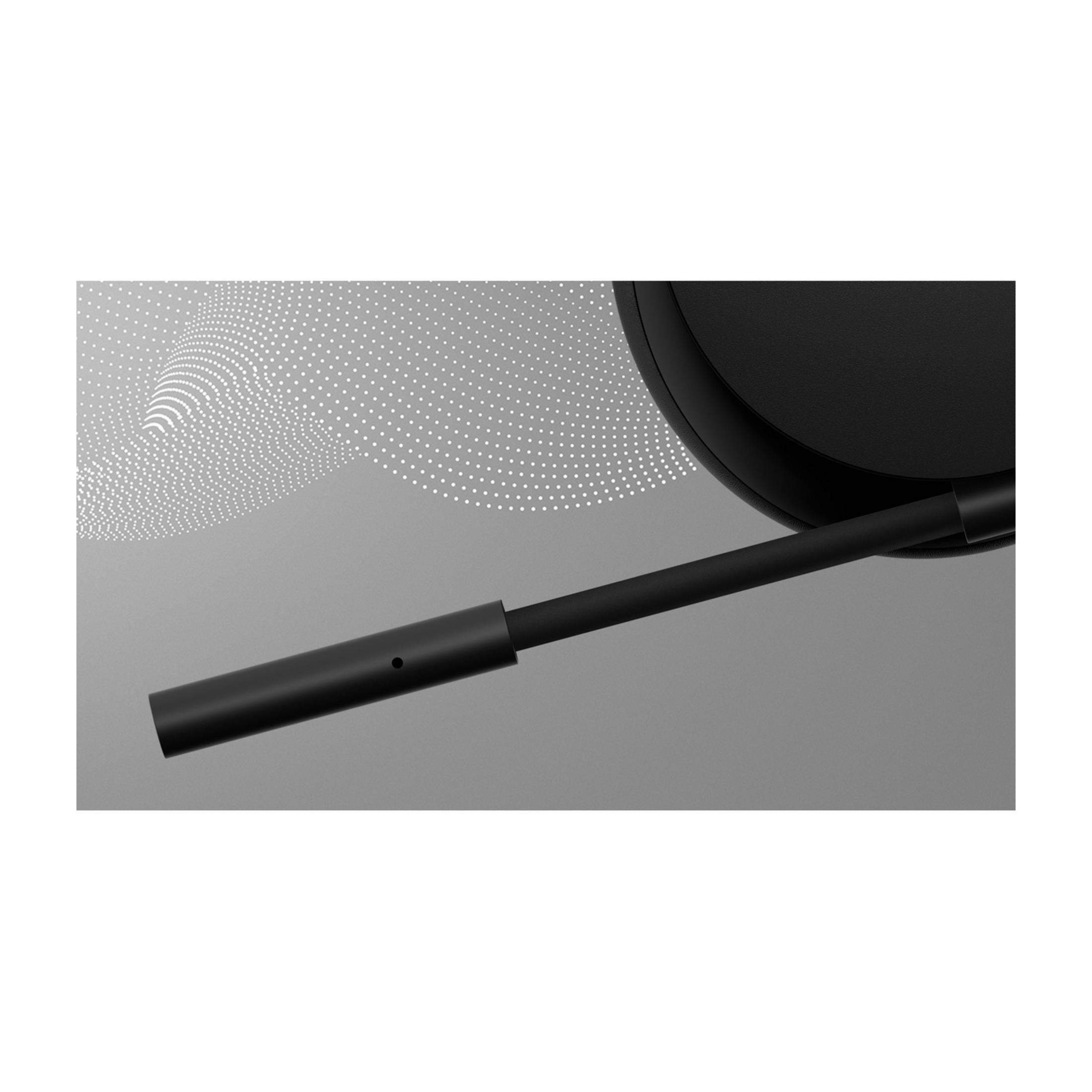Bras de microphone noir avec points blancs sur fond gris.
