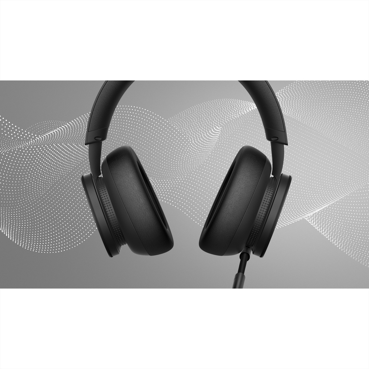 Casque noir avec écouteurs rembourrés sur fond gris avec des points lumineux.