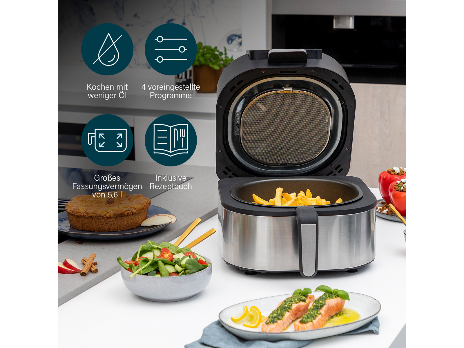 Otwarty frytkownica z frytkami, obok ciasto, sałatka, ryba i faszerowana papryka.