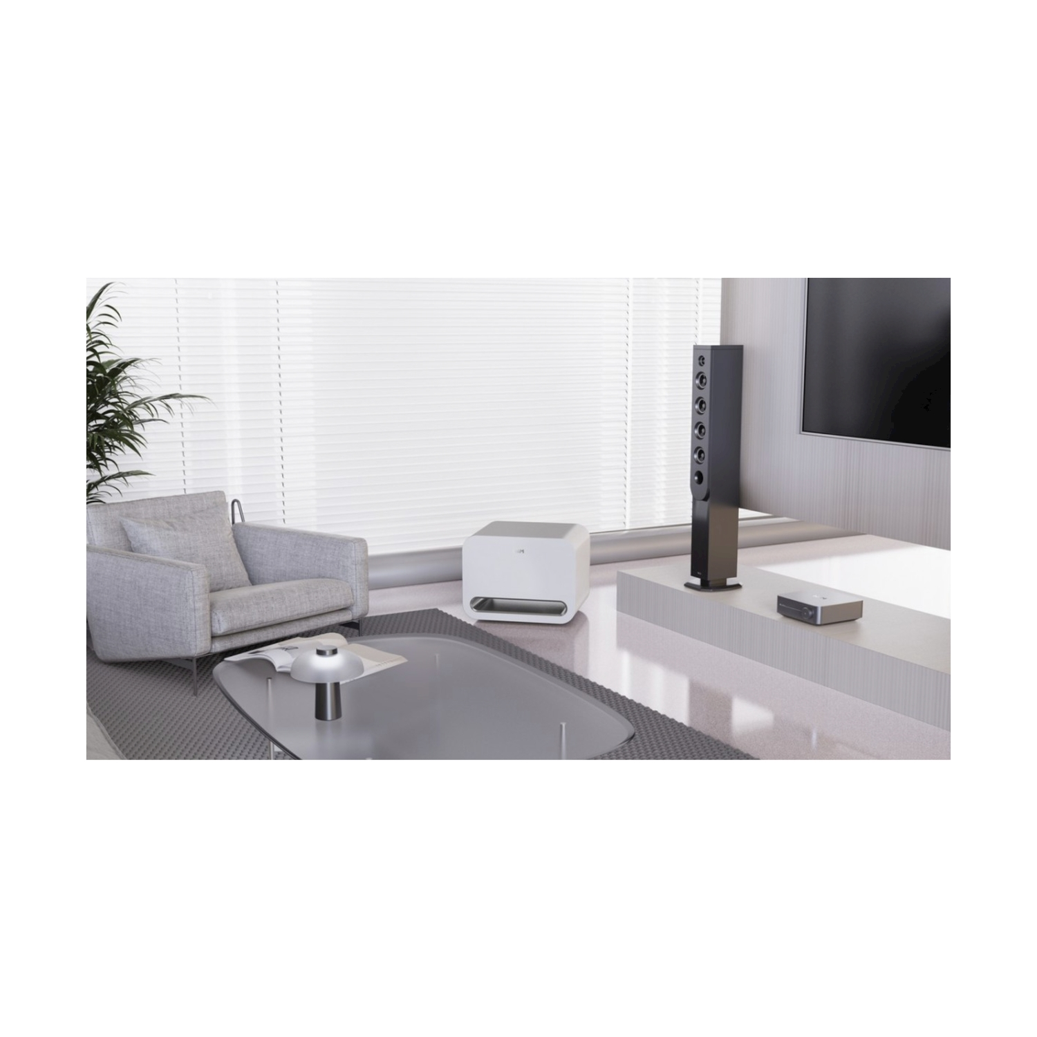 Wohnzimmer mit Sofa, Kaffeetisch, Lautsprecher und Fernseher.