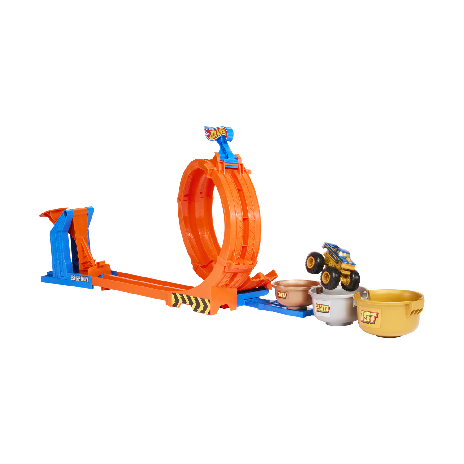 Ein gelbes Monster-Truck-Spielzeug springt über orangefarbene und blaue Bahnteile.