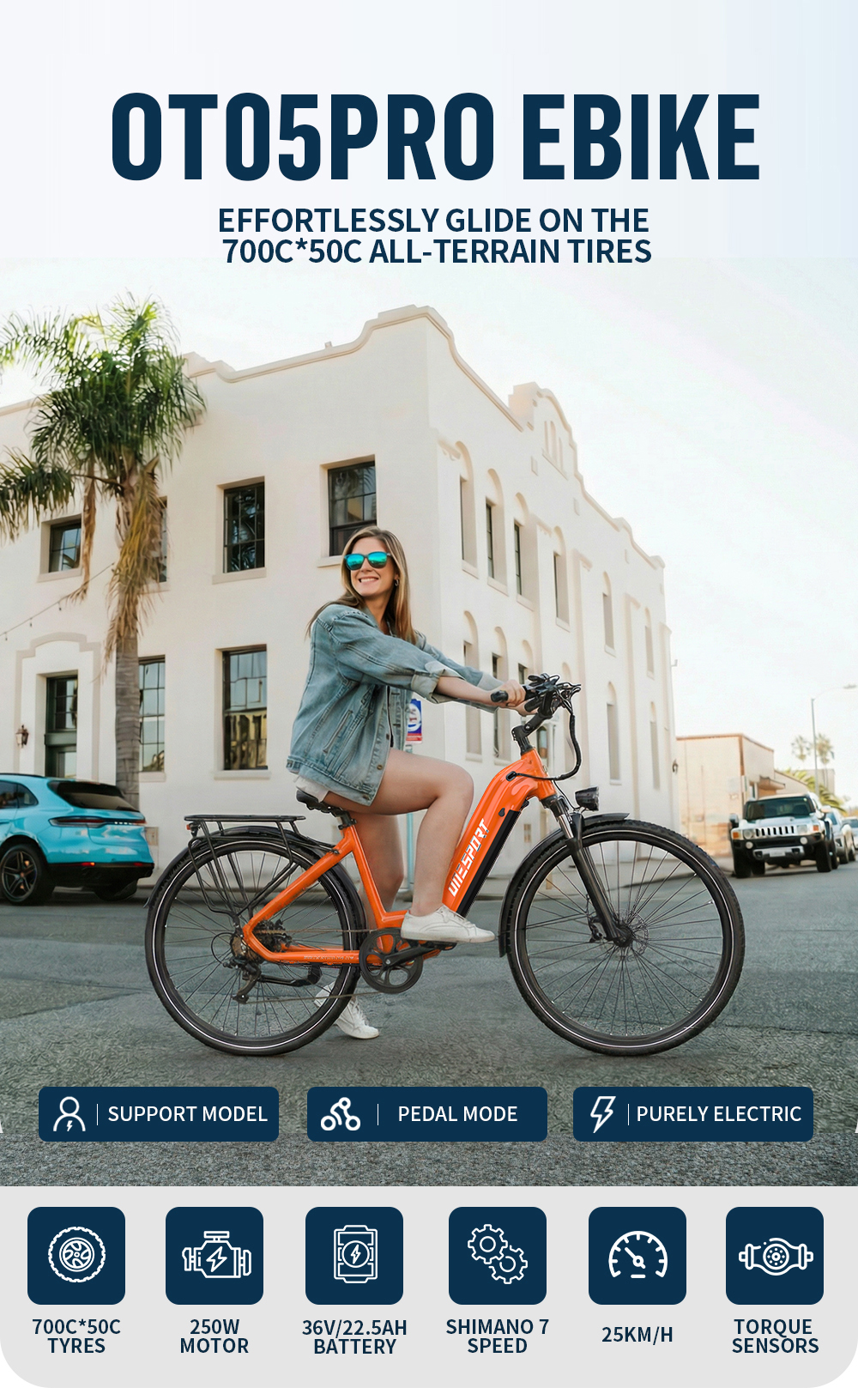 Una donna guida una e-bike arancione con pneumatici 700C*50C davanti a un edificio bianco.