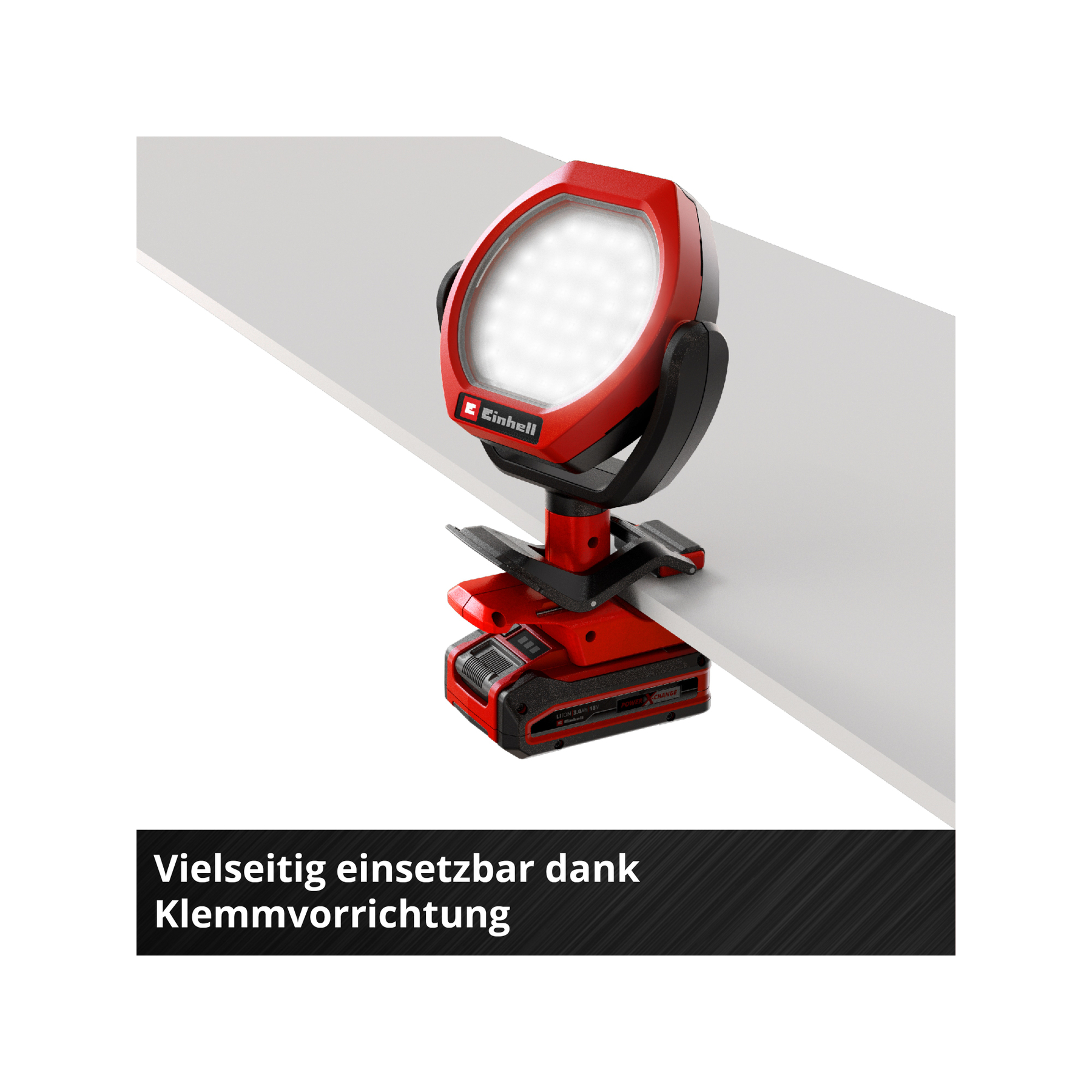 Czerwony reflektor akumulatorowy z zaciskiem na białej powierzchni. Logo Einhell.