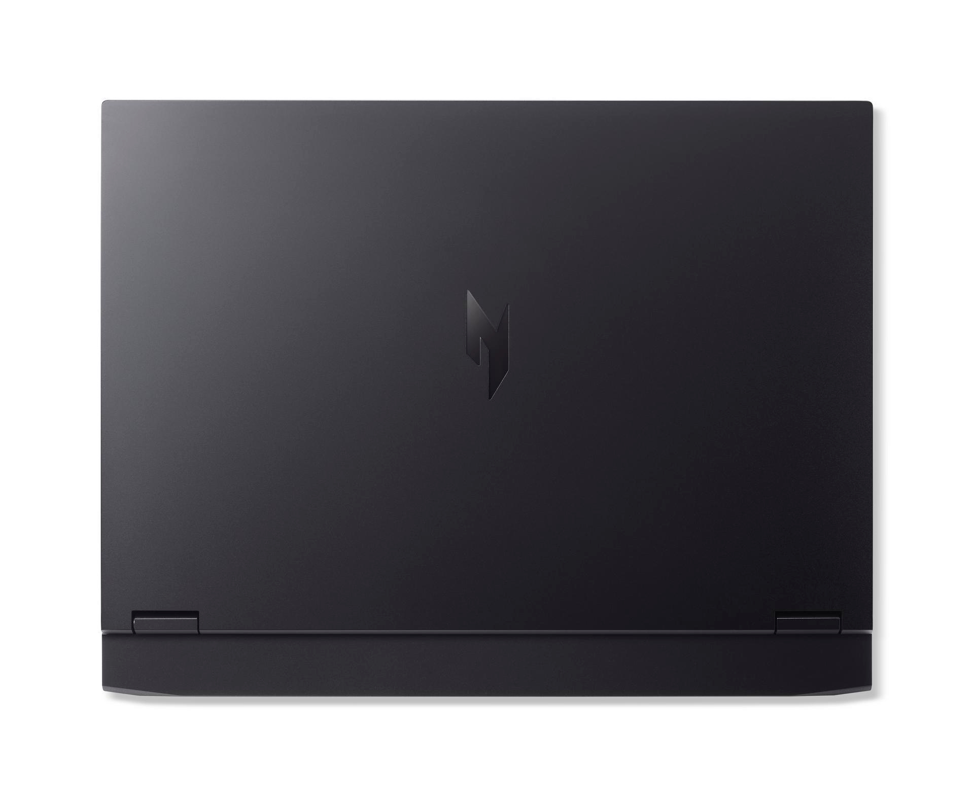 Zamknięty czarny laptop z srebrnym logo na górnej powierzchni.
