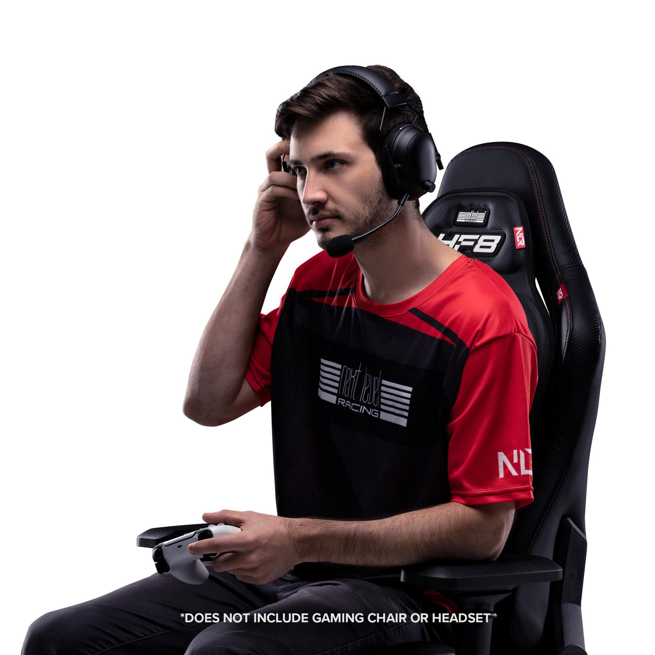 Man in rood shirt zit in gamestoel met controller.