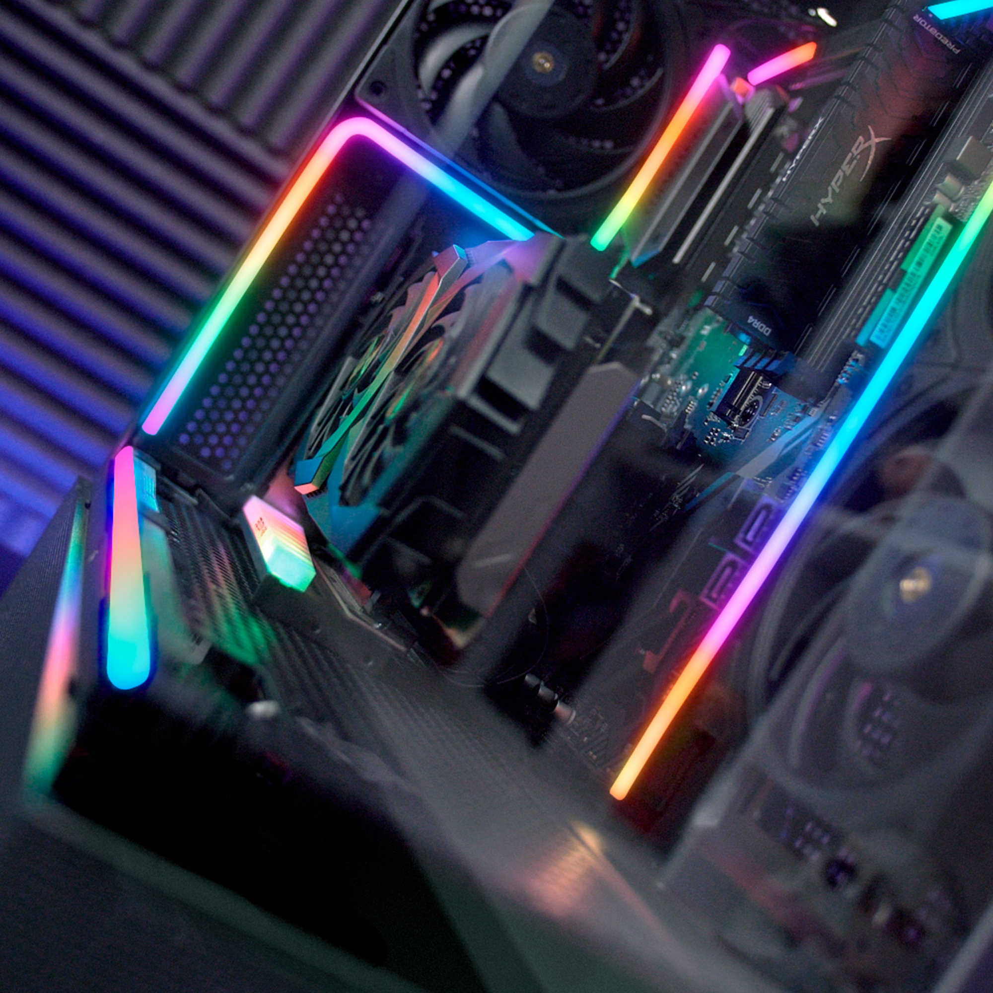 Una placa base de computadora con iluminación RGB y ventiladores.