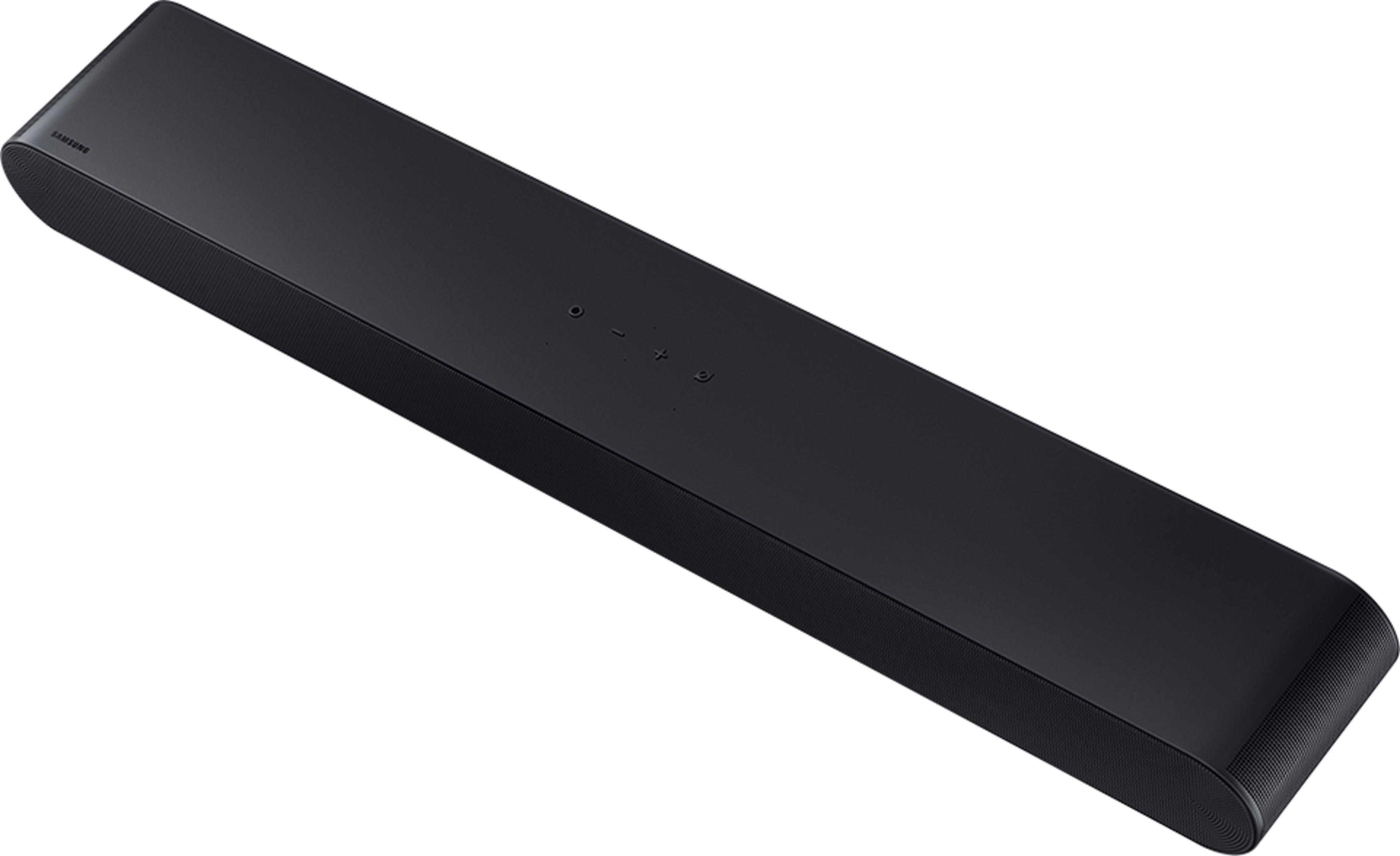 Soundbar Samsung nero con lati a coste e pulsanti in alto.
