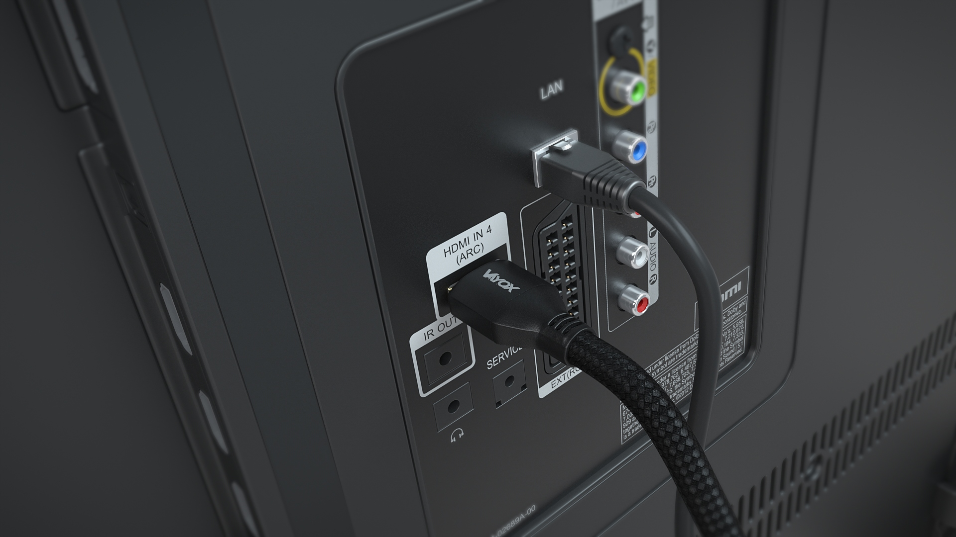 Zbliżenie na porty TV z podłączonymi kablami HDMI i LAN. Skupione na połączeniach.