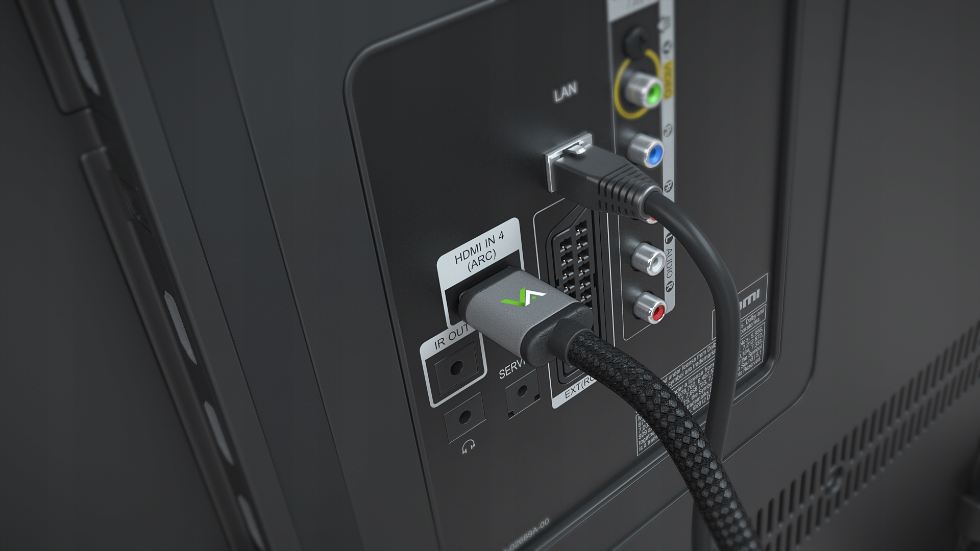 Zbliżenie portów telewizora z podłączonymi kablami HDMI i LAN.