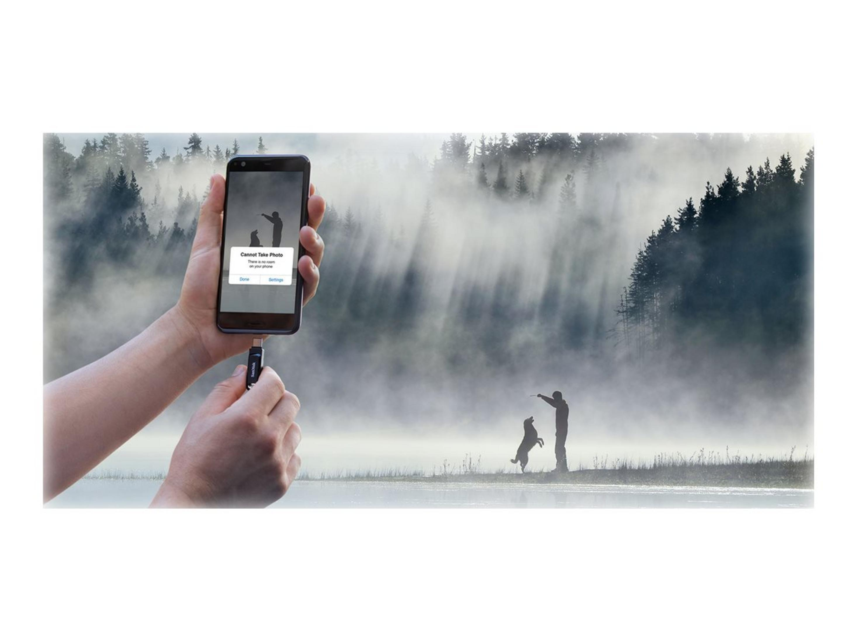 Hand holds phone with error message, man with dog in foggy background.