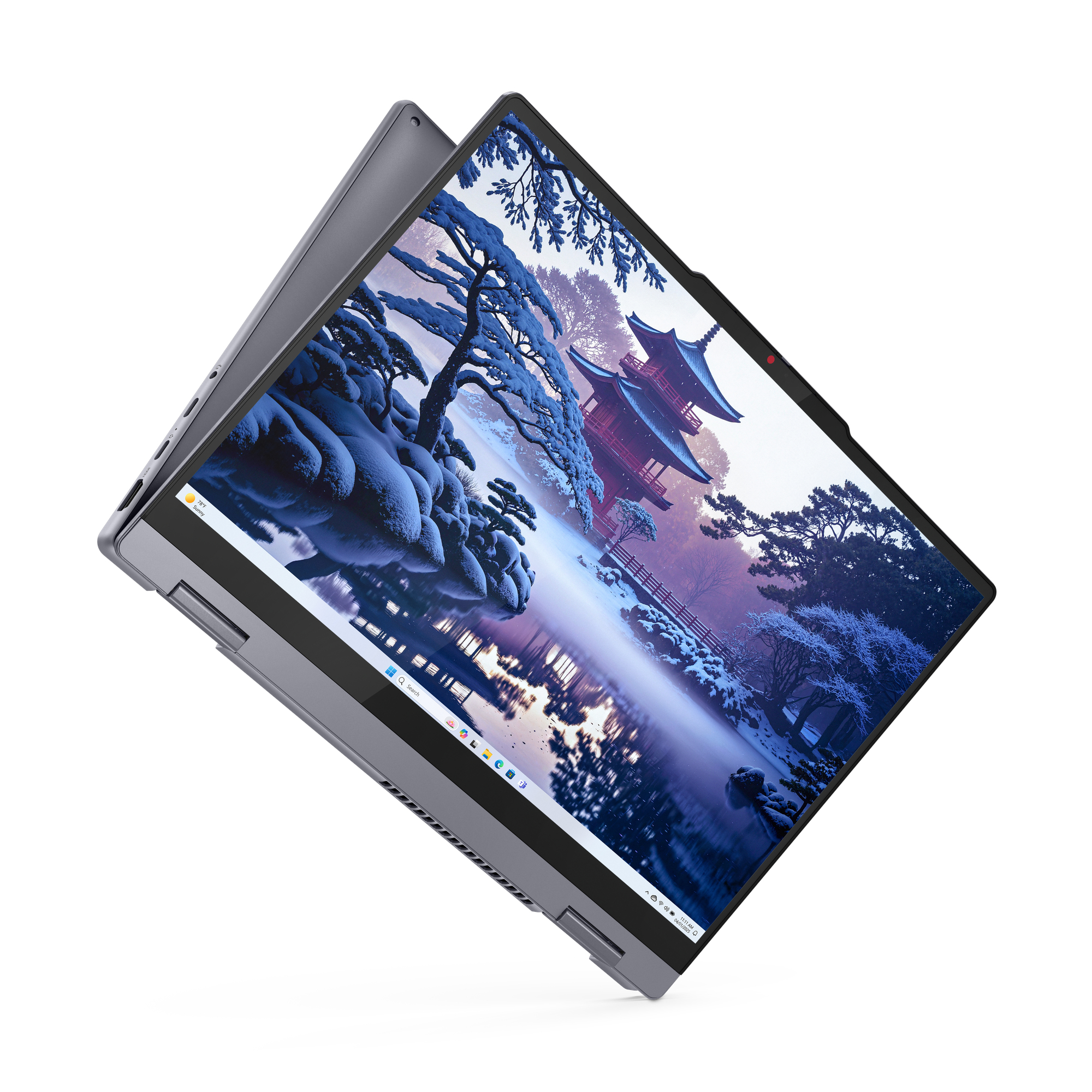 Ein Laptop mit einem Winterbild eines japanischen Tempels und schneebedeckten Bäumen.