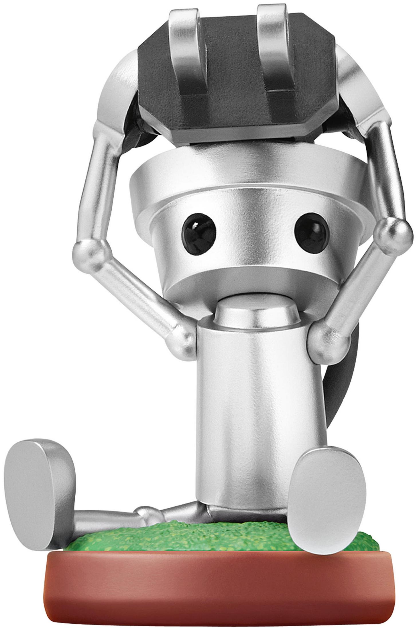 Eine kleine silberne Roboterfigur sitzt auf einer grünen Fläche mit braunem Sockel.