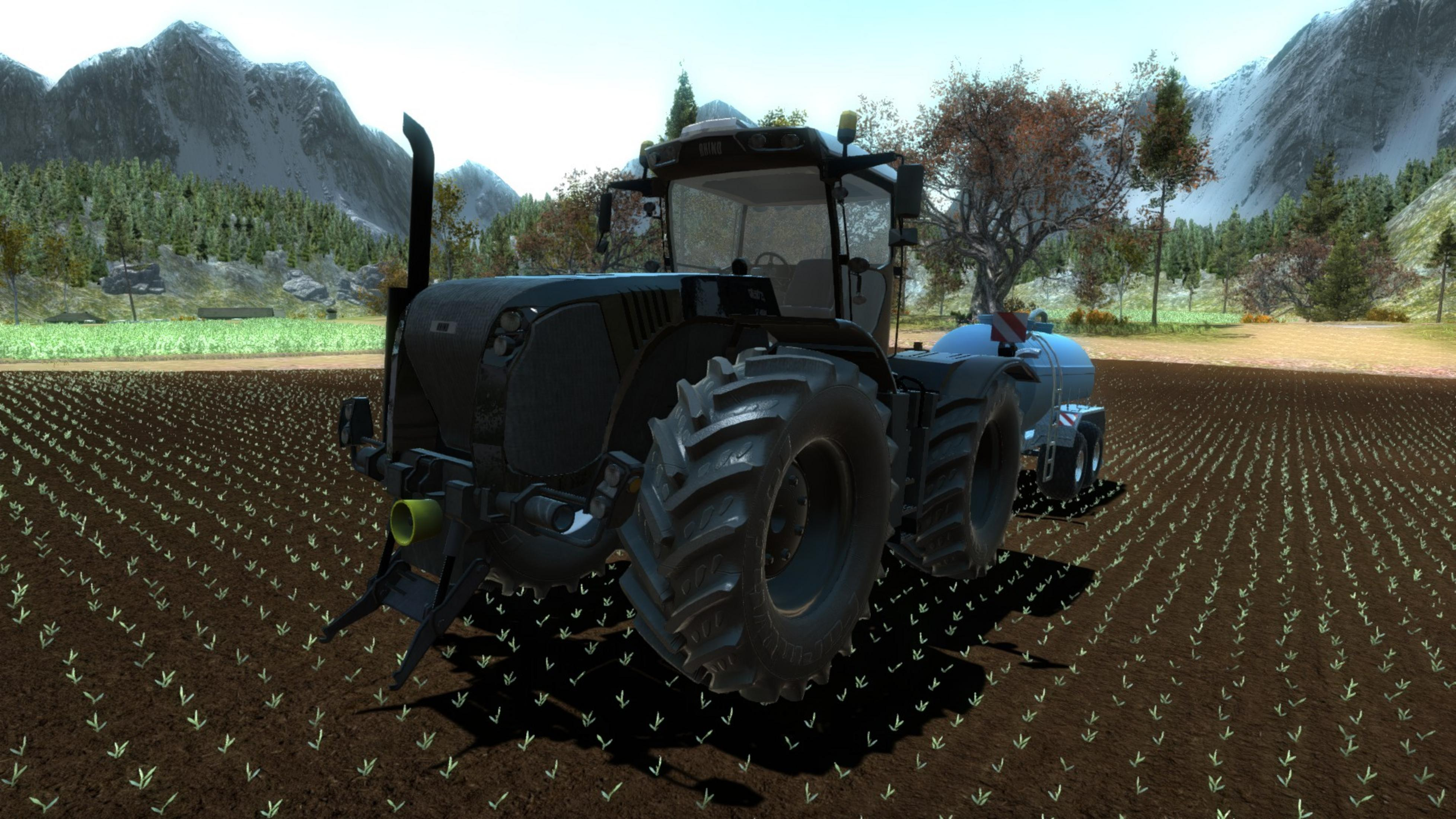 Ein schwarzer Traktor mit einem Wassertank fährt auf einem Feld mit jungen Pflanzen.