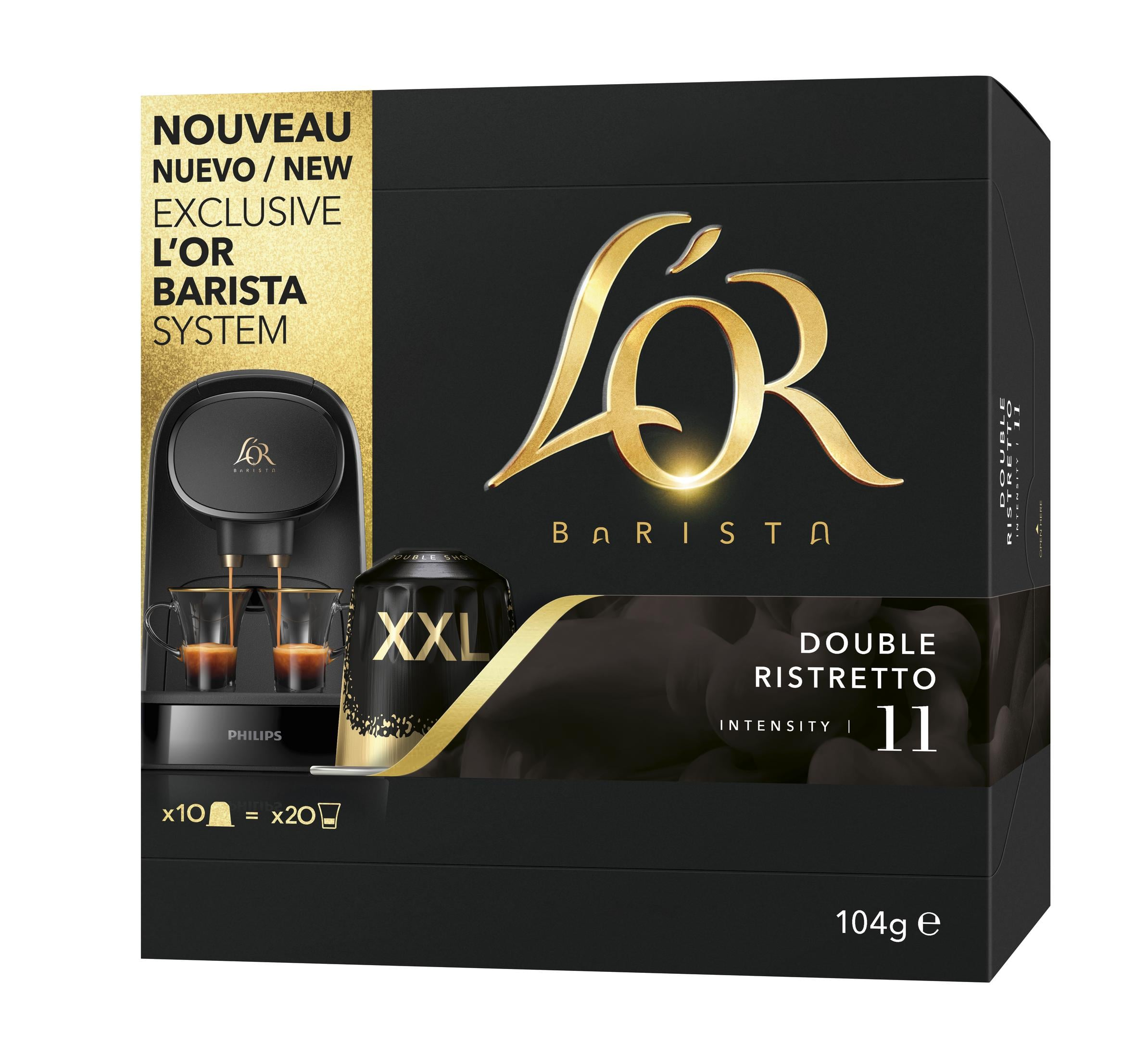 Macchina da caffè L'OR Barista con due tazze di caffè e confezione di capsule.