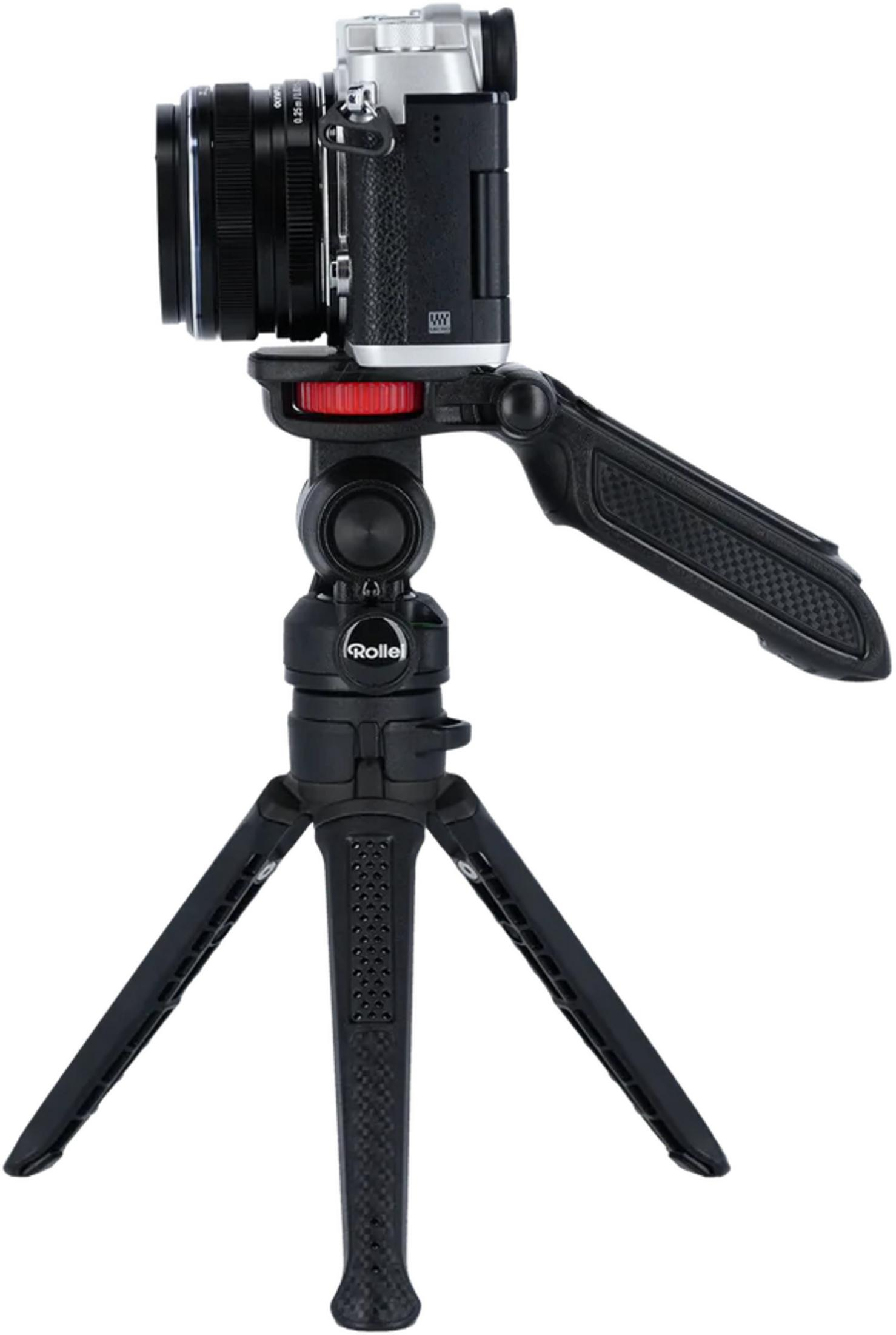 Fotocamera con obiettivo su un piccolo treppiede nero con accenti rossi.