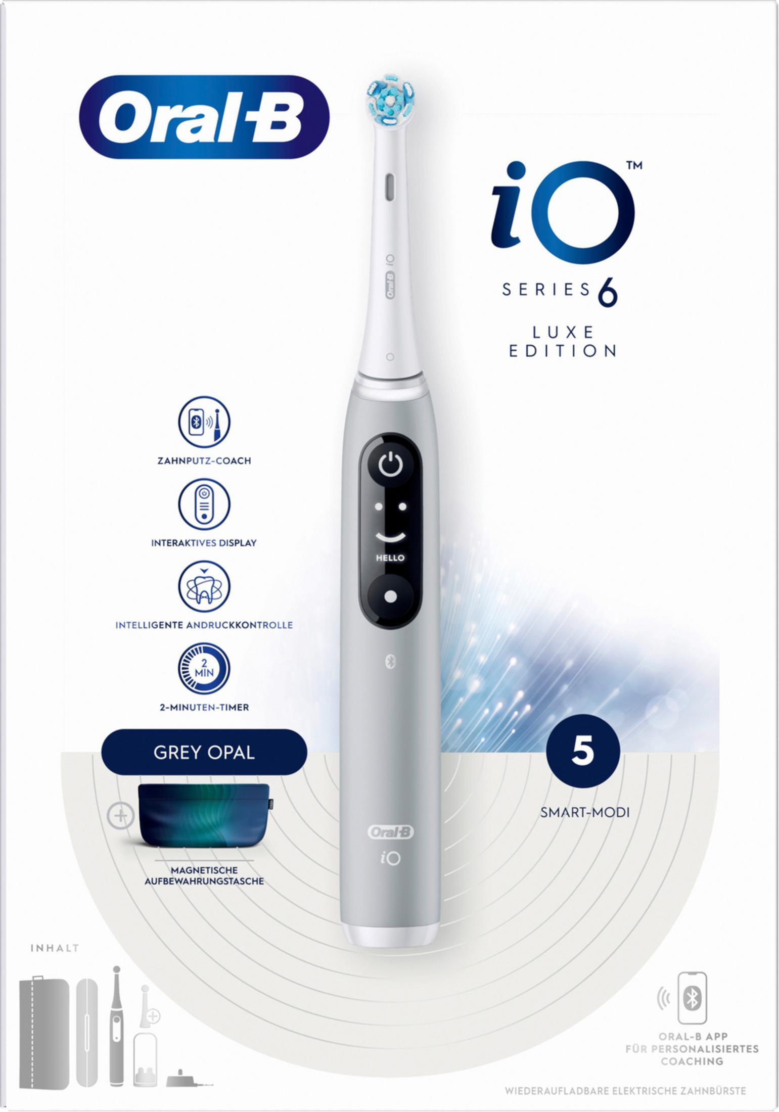 Szara elektryczna szczoteczka do zębów Oral-B iO Series 6 Luxe Edition z akcesoriami.
