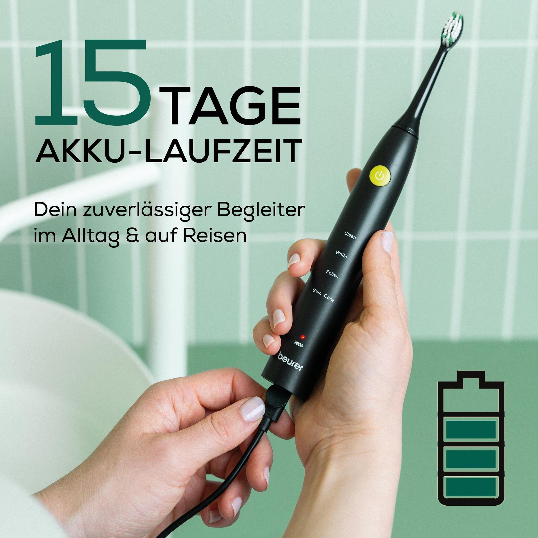 Une personne charge une brosse à dents électrique noire avec texte '15 jours