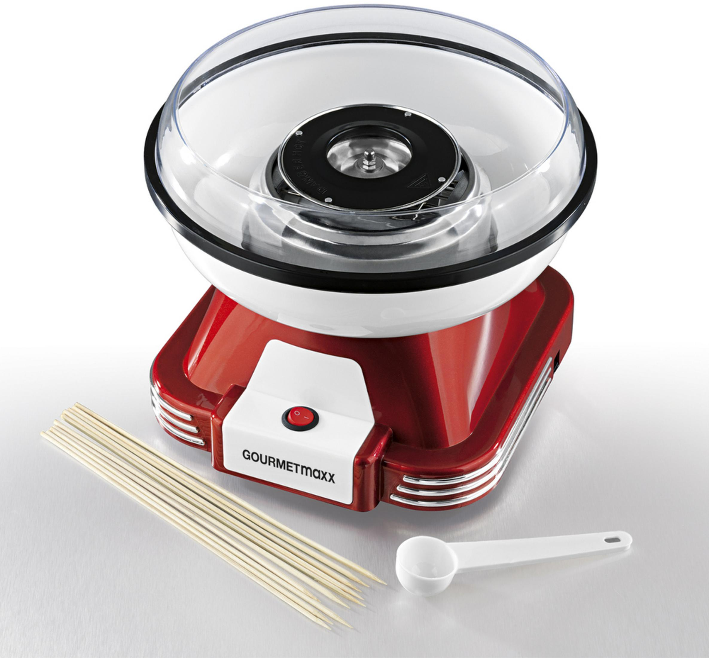 Rot-weiße Zuckerwattemaschine mit Stöcken und Löffel.