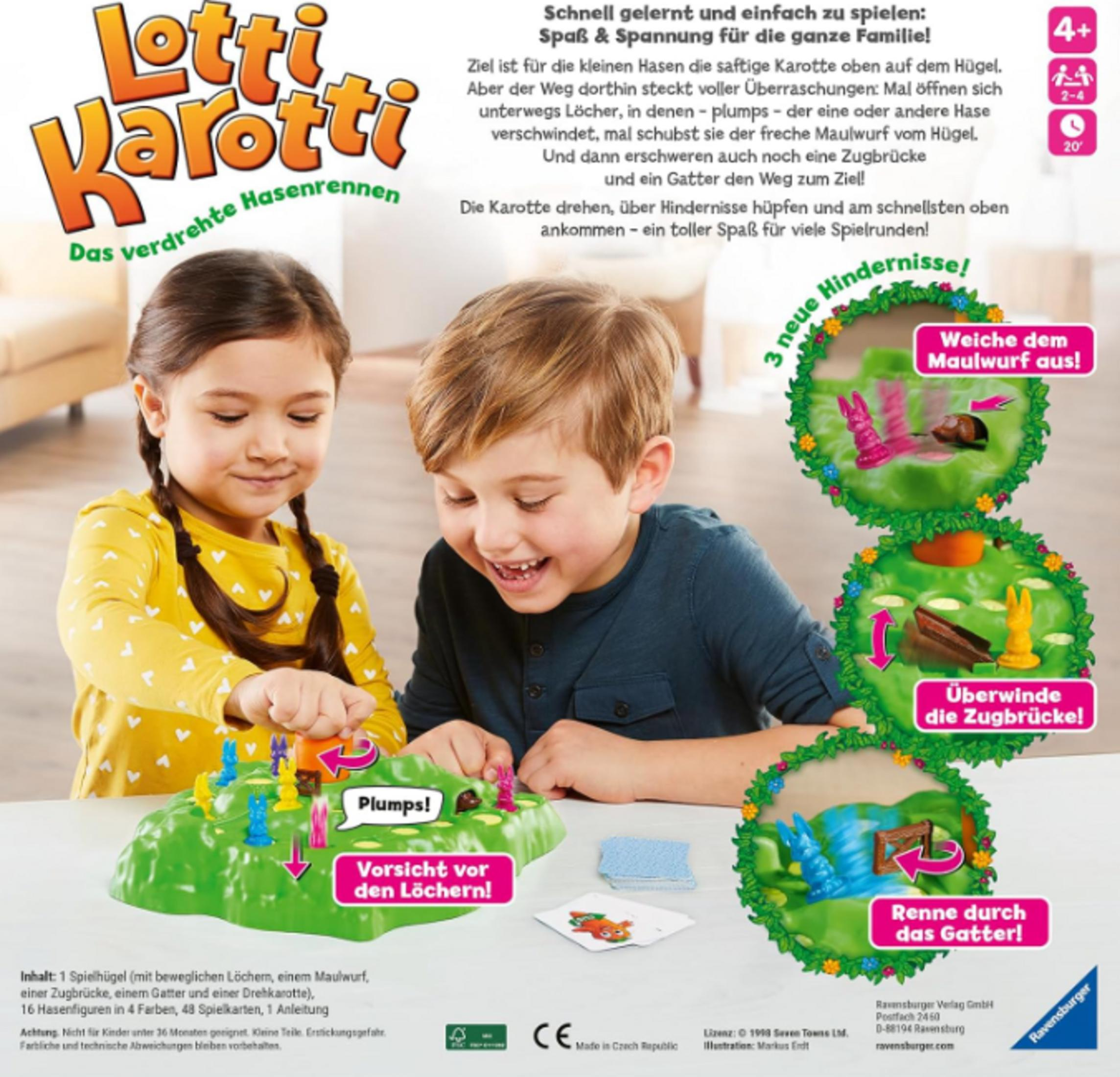 Dzieci grają w grę planszową z figurkami króliczków i marchewek na zielonym wzgórzu.