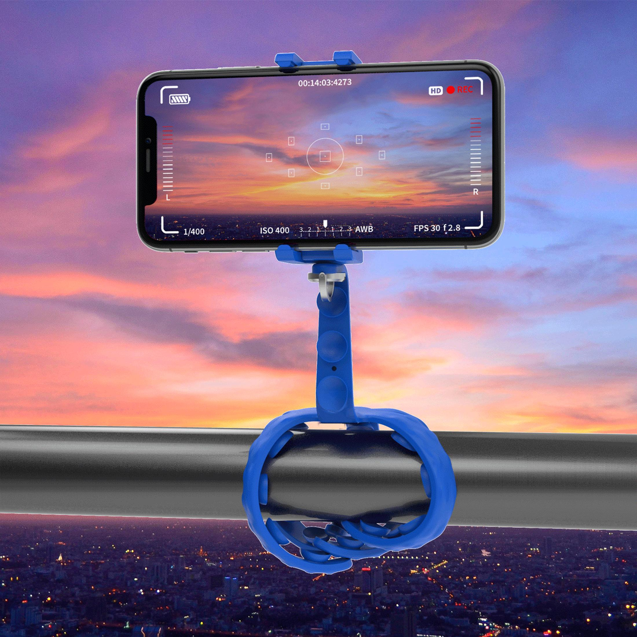 Smartphone-Halterung mit Kamera-Interface über Stadtbild bei Sonnenuntergang.