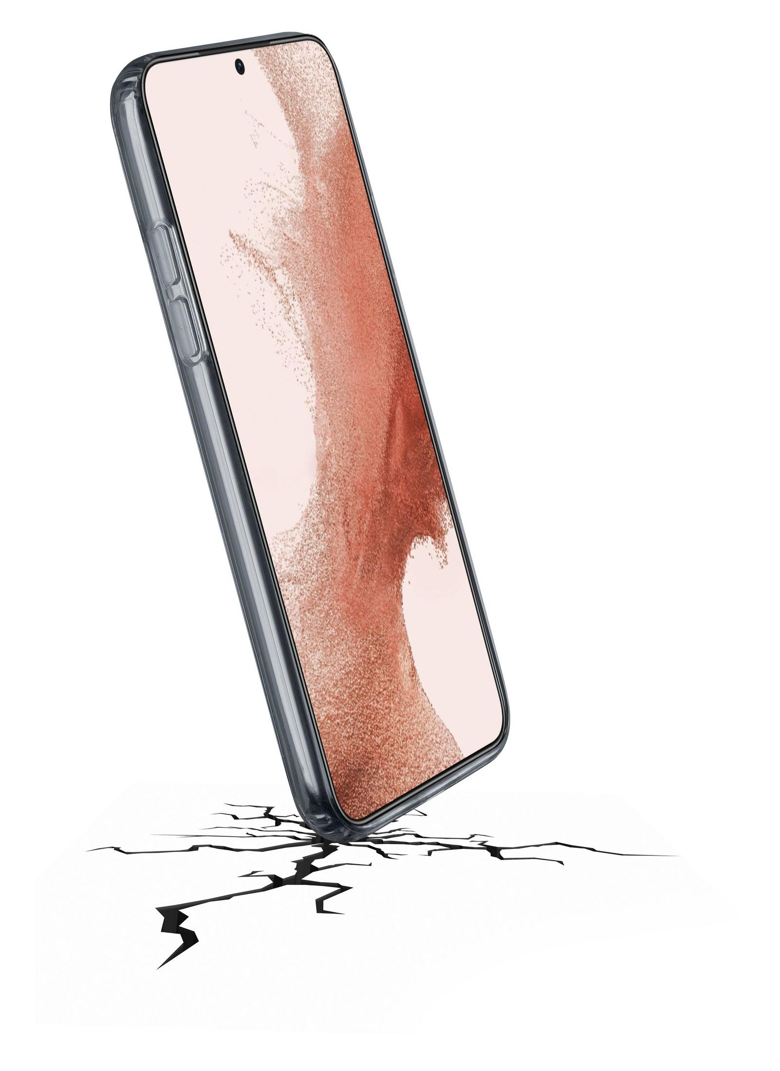 Un telefono trasparente cade su una superficie bianca con crepe.