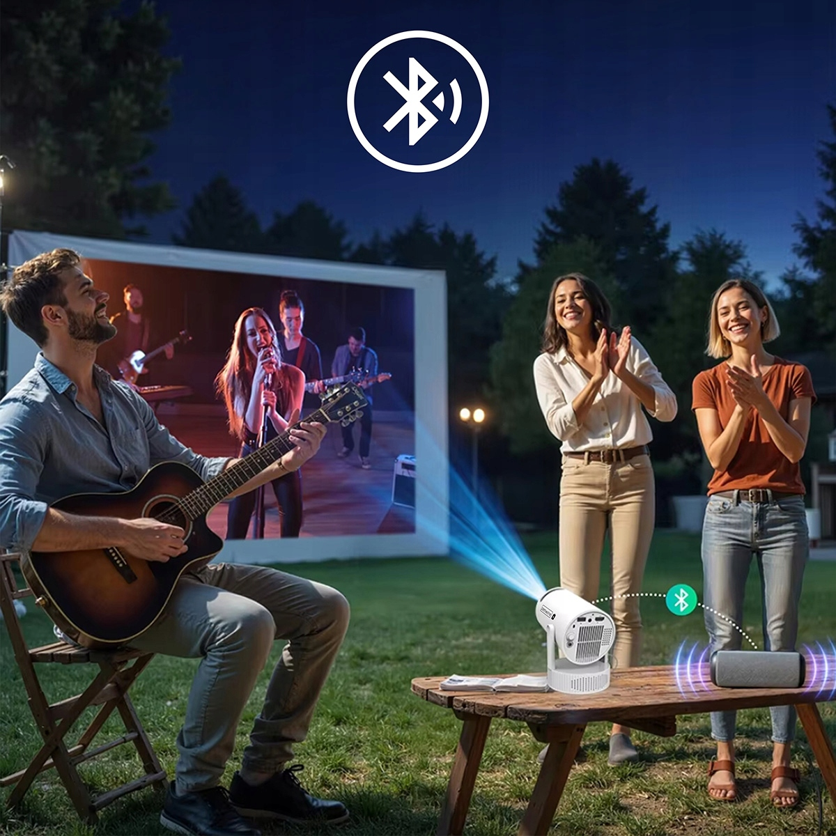 Ludzie cieszą się filmem na świeżym powietrzu z projektorem i głośnikiem. Pokazano ikonę Bluetooth.