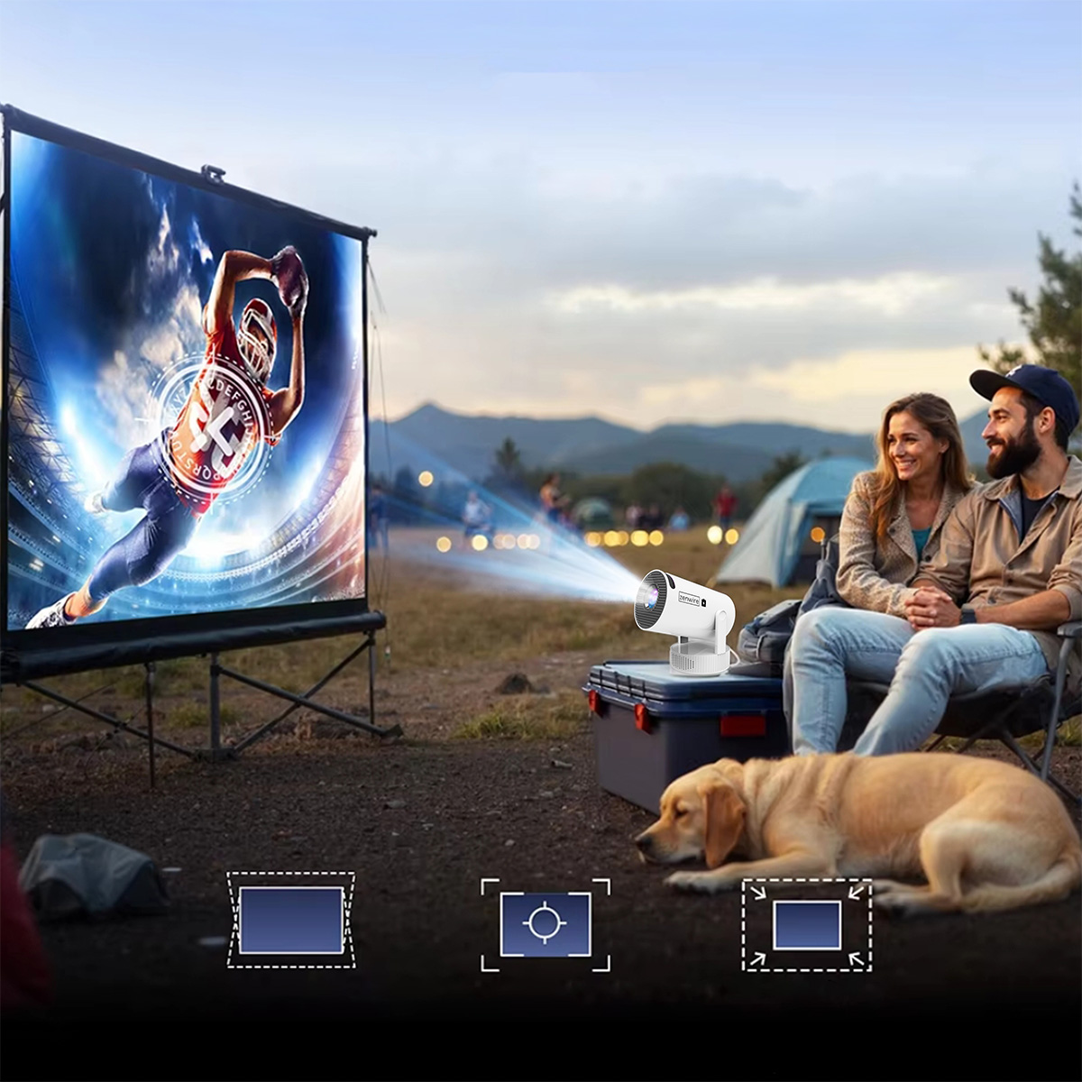 Para i pies oglądają gracza futbolu amerykańskiego na zewnętrznym ekranie projekcyjnym.