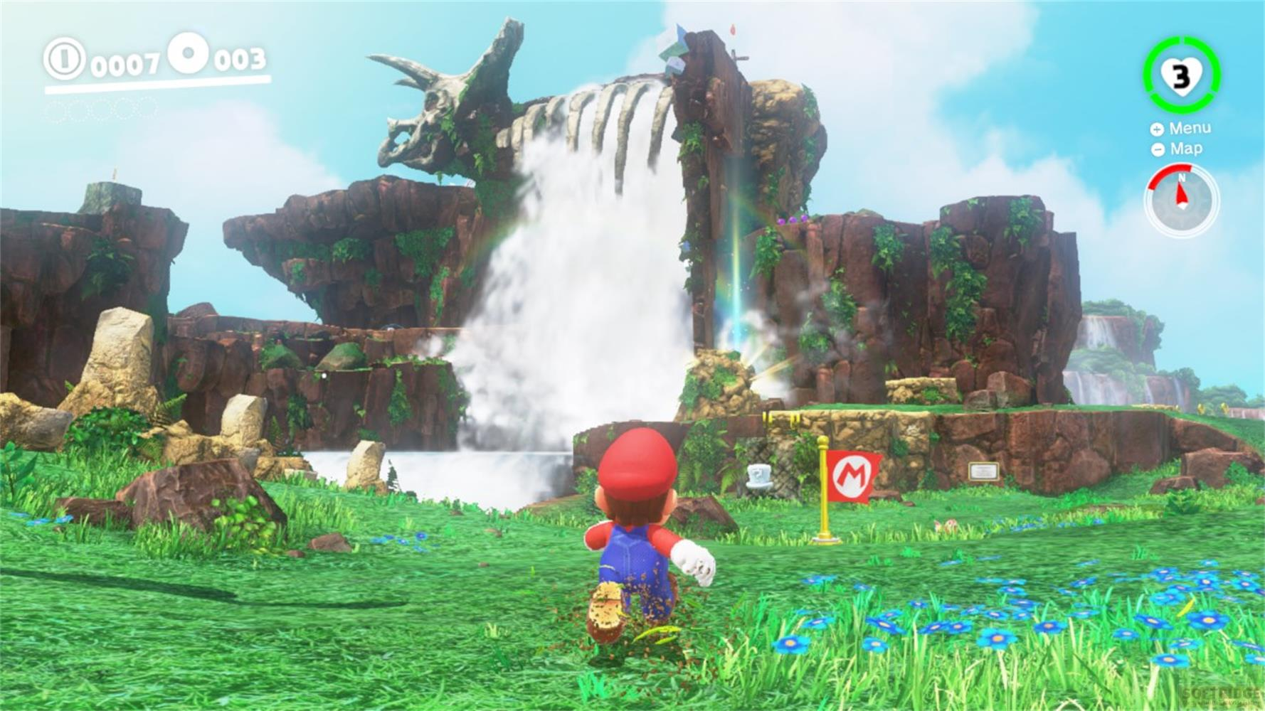 Mario rennt auf eine riesige Wasserfall-Landschaft mit Felsen und grüner Wiese zu.