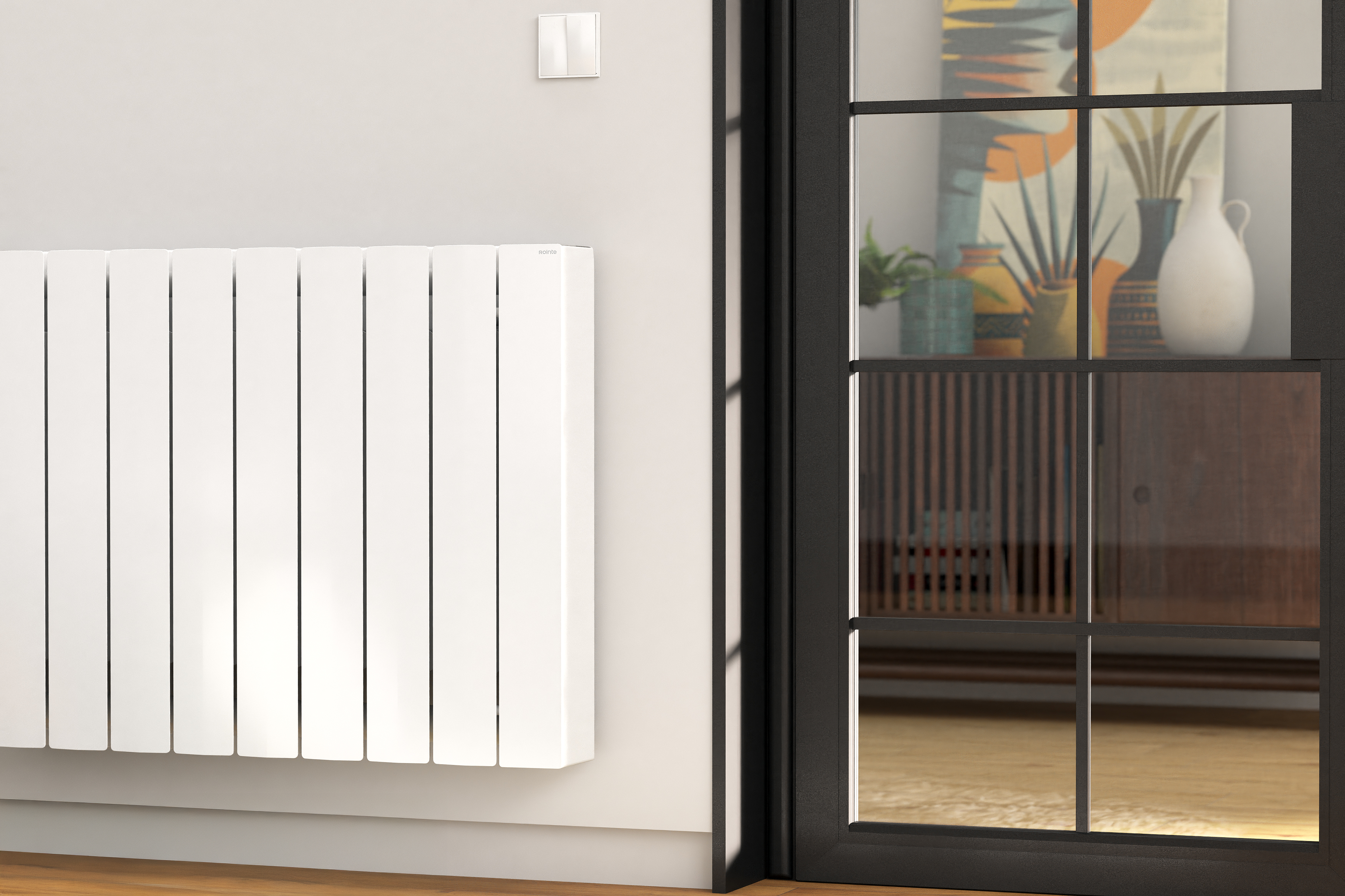 Un radiador blanco con aletas verticales en una pared, junto a una puerta de cristal.