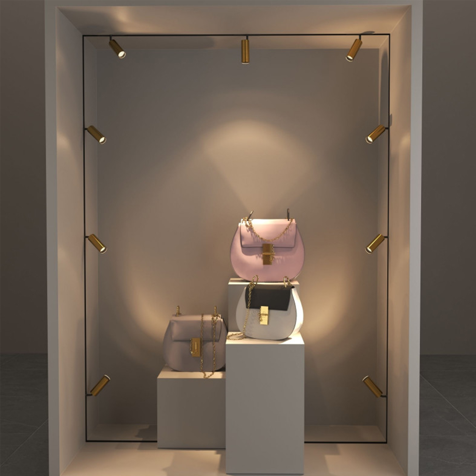 Tres bolsos, uno rosa, uno gris y uno bicolor, expuestos en un escaparate.