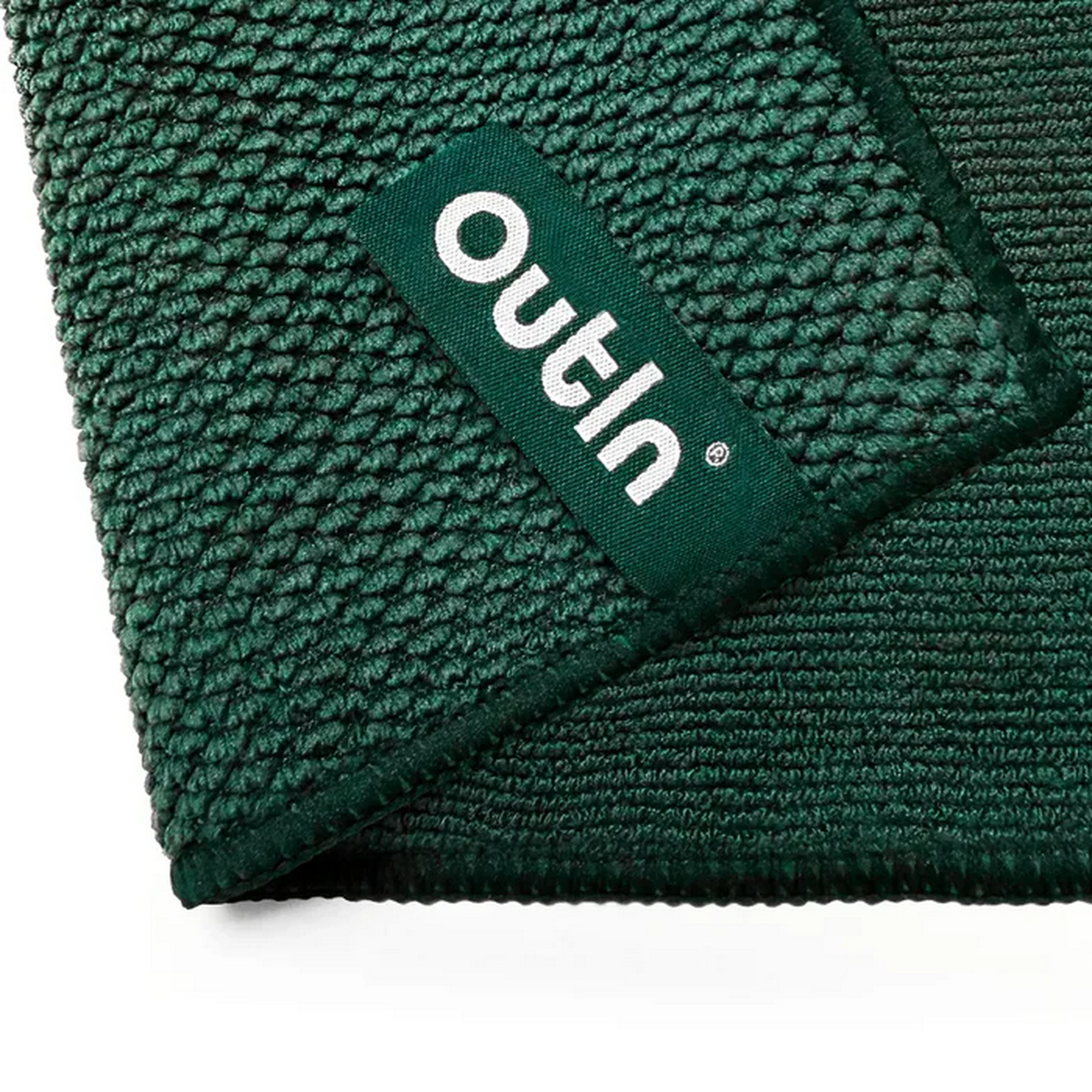 Groen textiel met "Outin" logo.