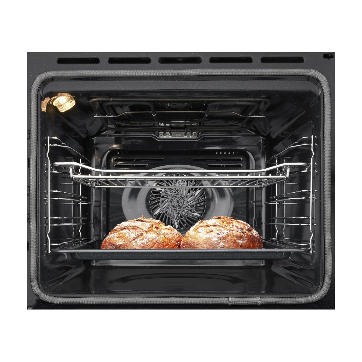 Dos panes horneándose en un horno oscuro sobre una rejilla.