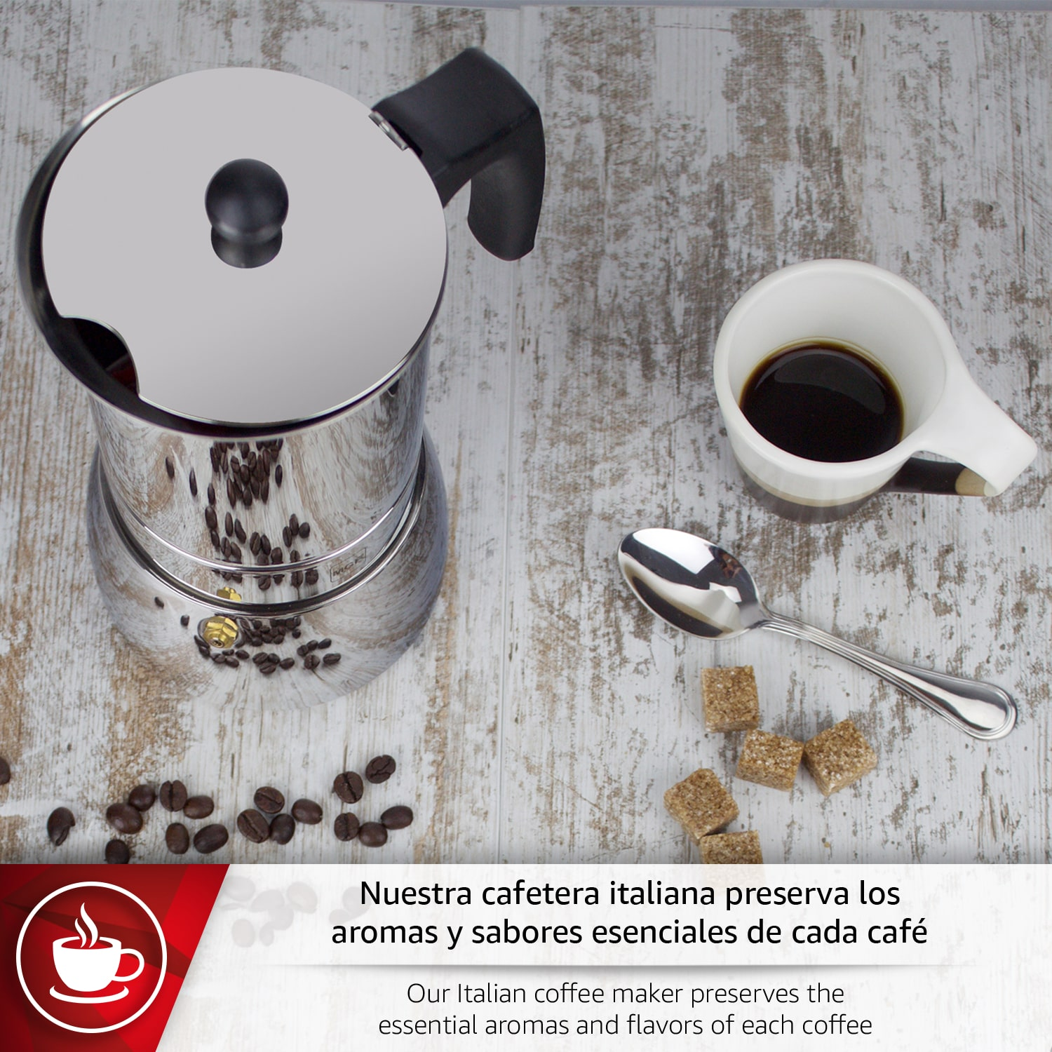 Una cafetera italiana con taza, granos de café, terrones de azúcar y cuchara.