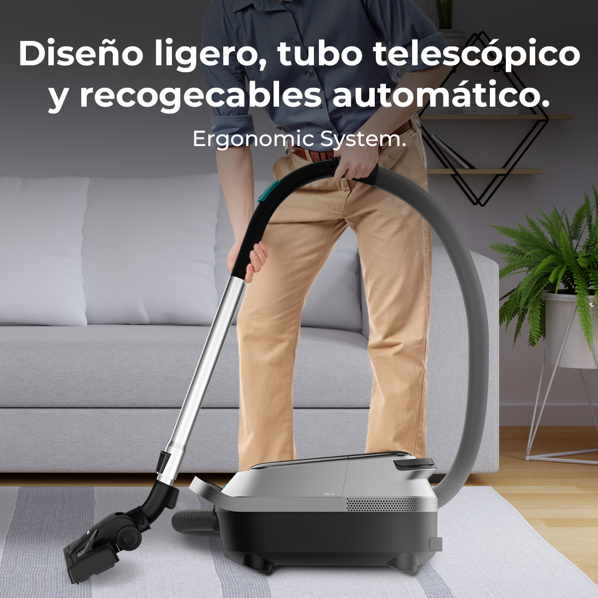 Una persona usa una aspiradora plateada con manguera en una sala de estar.