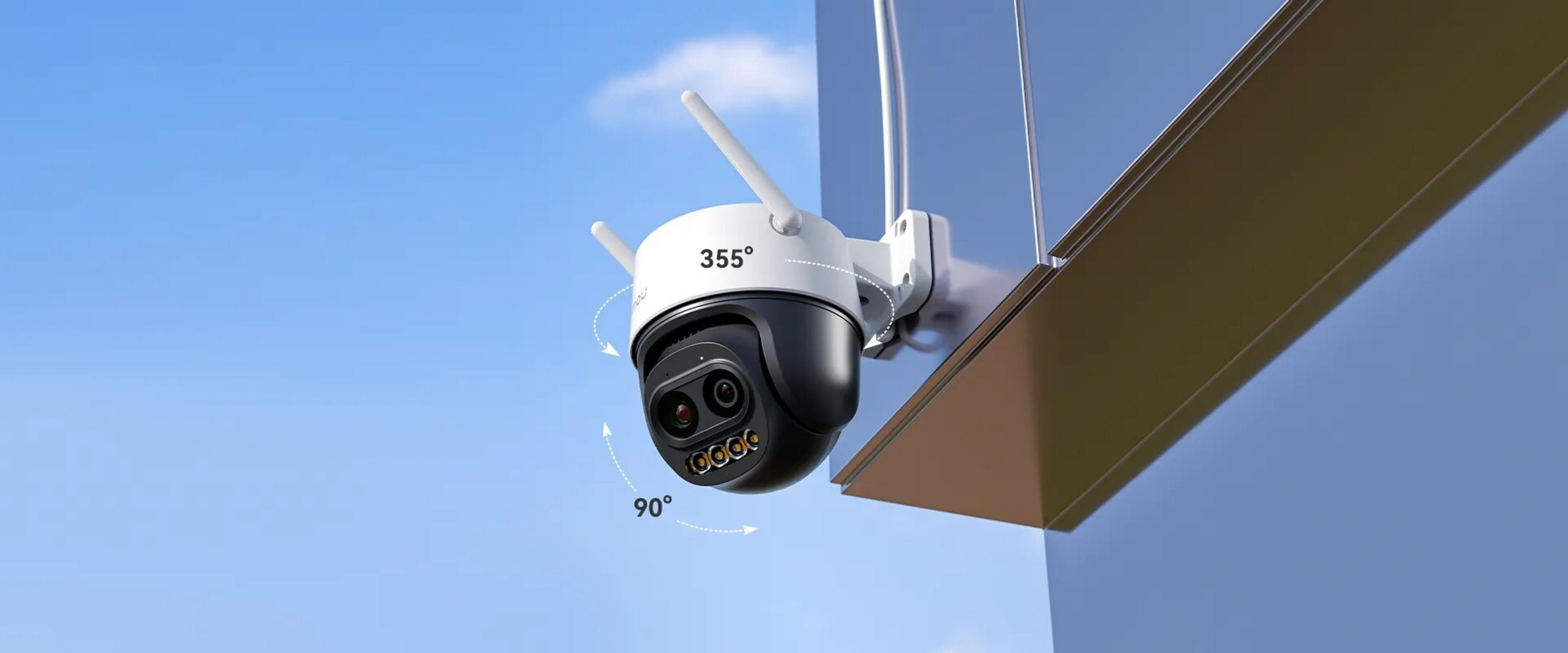A security camera mounted on a wall under a blue sky, showing 355° horizontal and 90° vertical rotation.