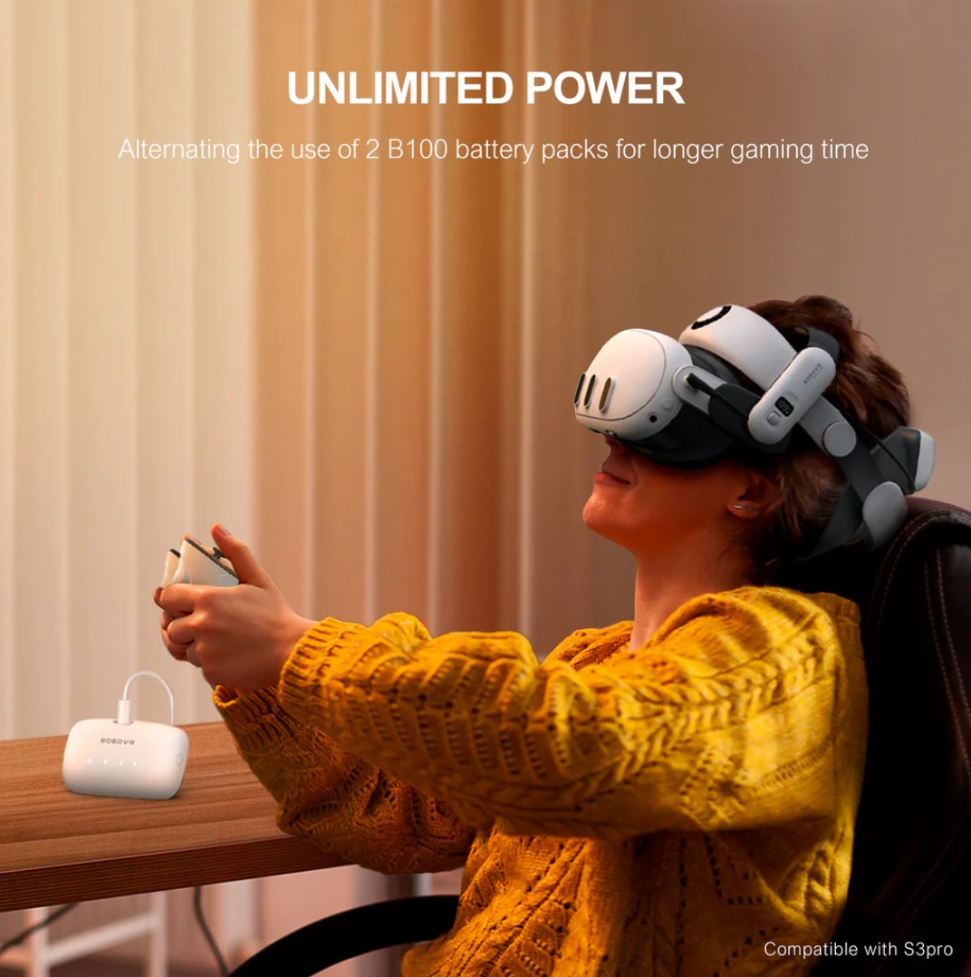 Persona con visore VR e controller, con pacco batteria bianco sul tavolo.