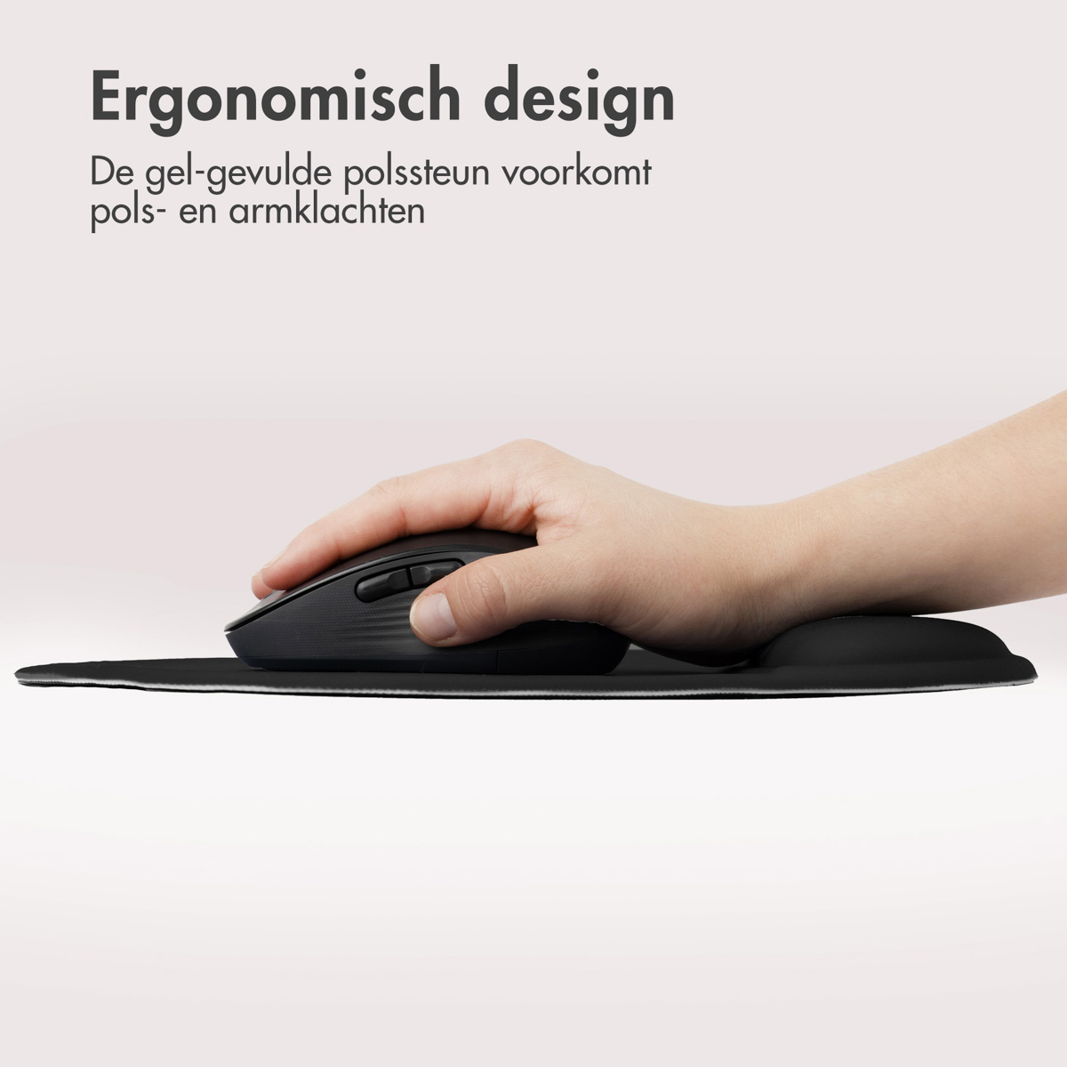 A hand uses a black mouse on a mousepad with a wrist rest.