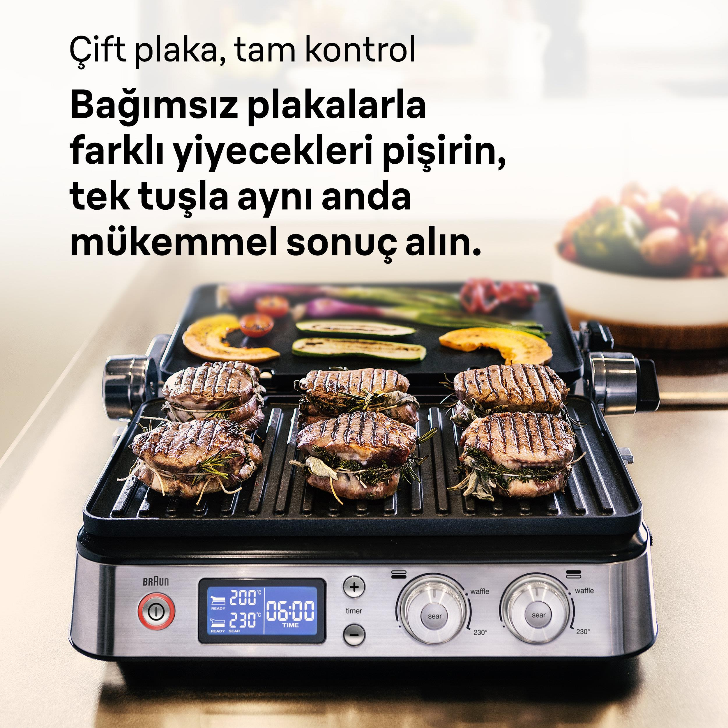 Ein Grill mit gegrilltem Fleisch und Gemüse. Links ist der Braun-Grill zu sehen.